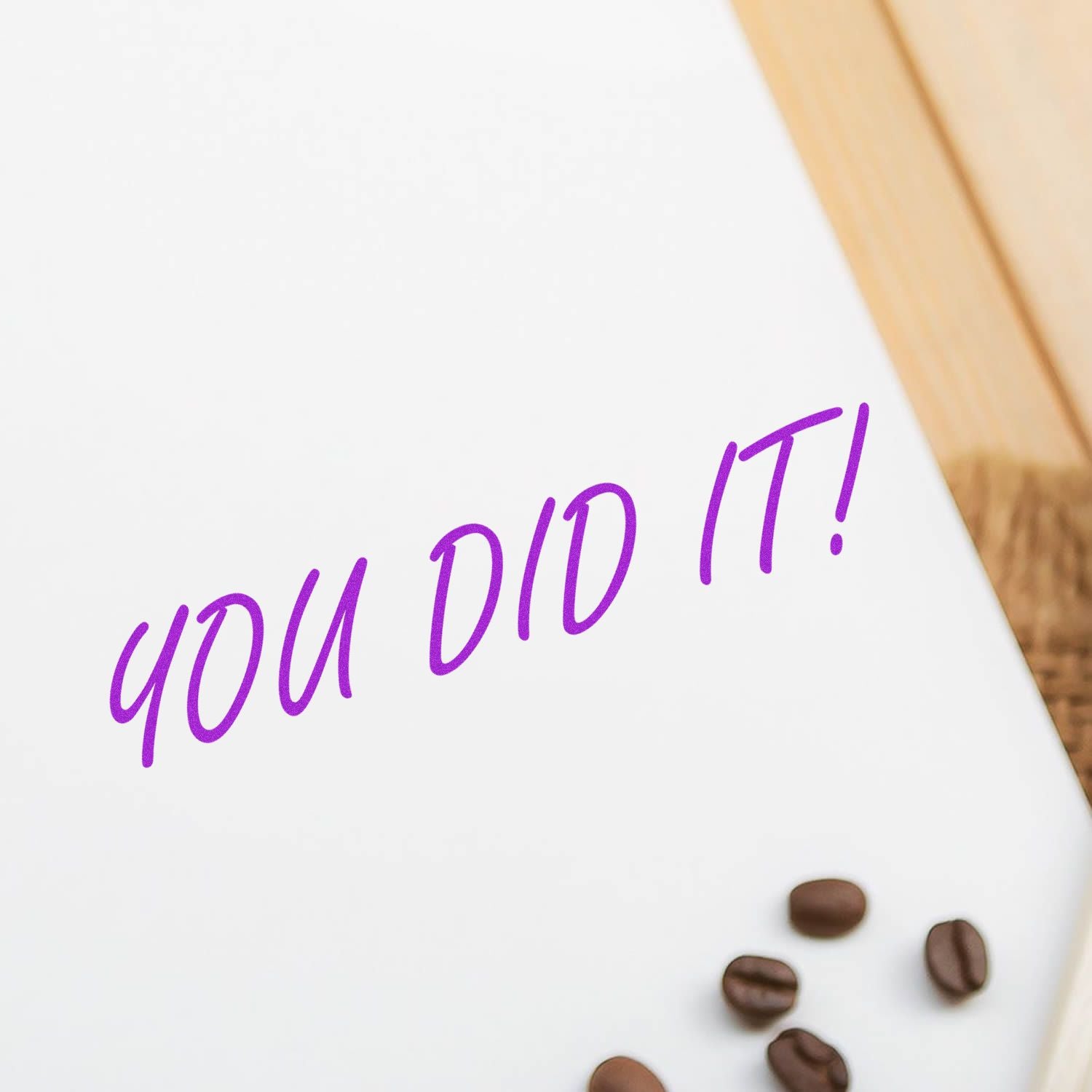 You did it! purple handwritten congratulatory note with coffee beans on a white background, celebration message.