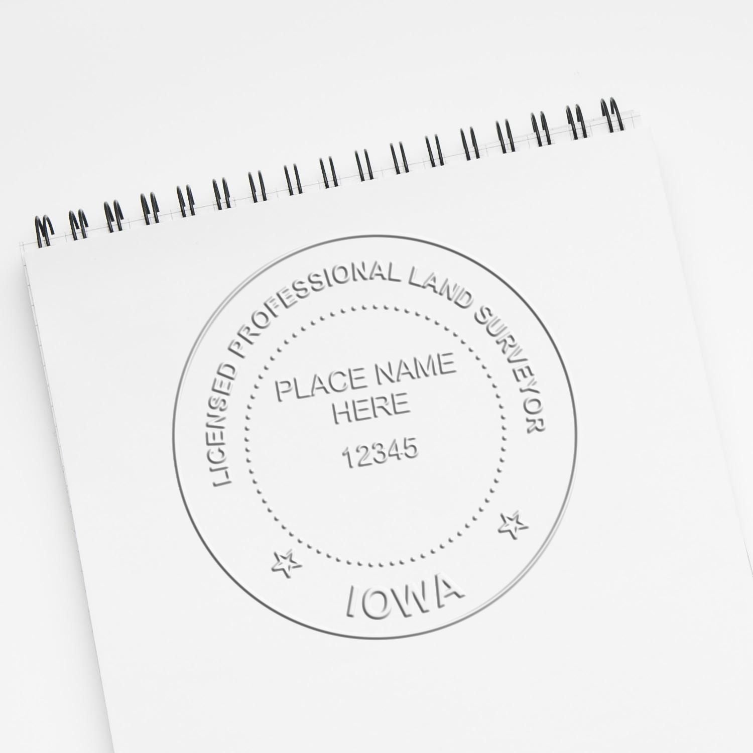 Custom embossed spiral notebook for licensed professional land surveyor in Iowa with logo and placeholder text.