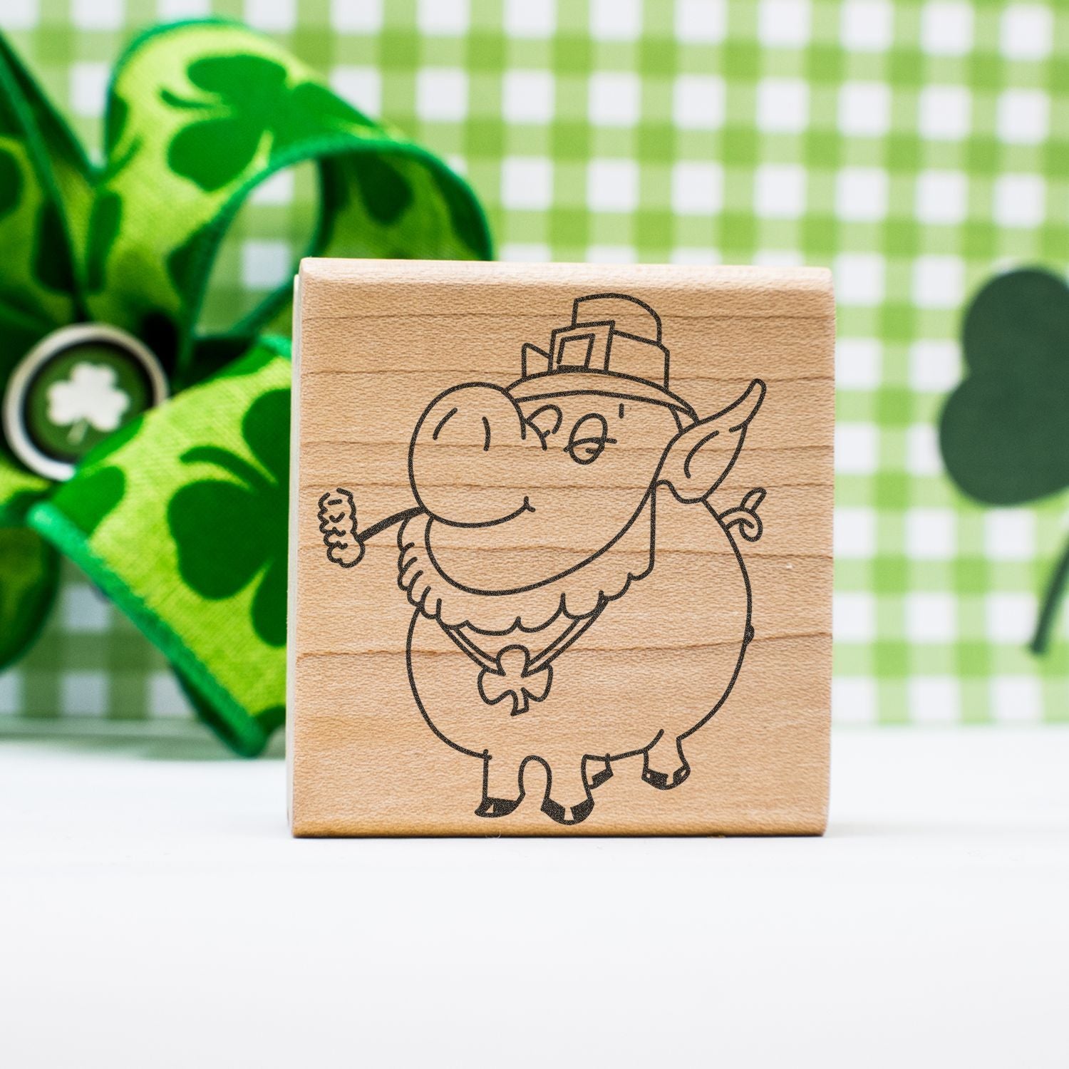 Wooden leprechaun stamp with shamrock design for St. Patricks Day crafting on a green festive background