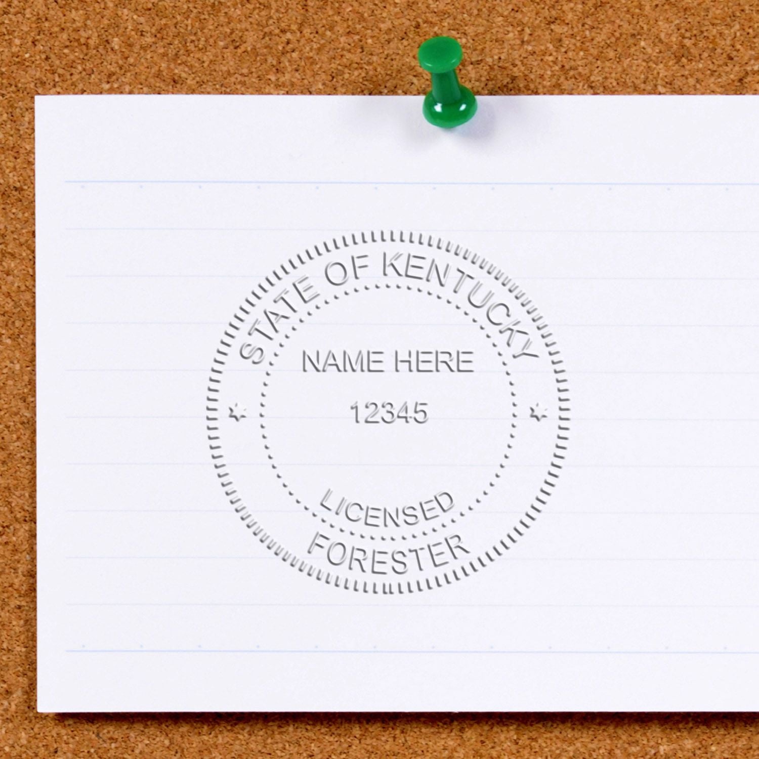 Blank paper pinned to corkboard with green pushpin, featuring a State of Kentucky Licensed Forester seal stamp.