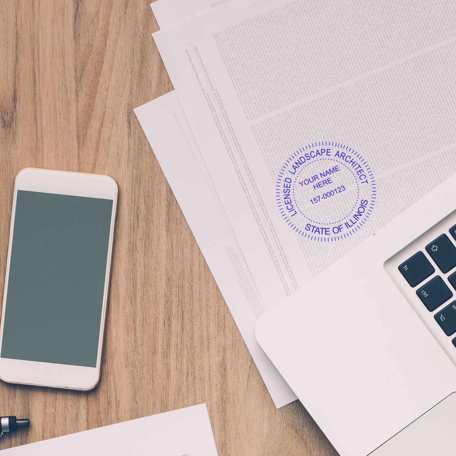 Laptop, smartphone, and documents on desk with licensed landscape architect stamp in Illinois.