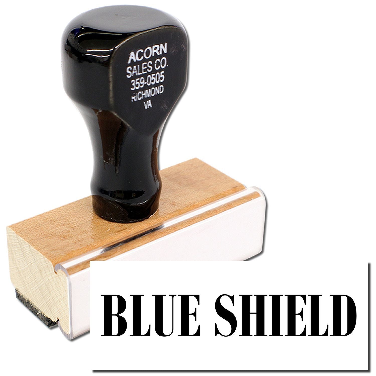 Blue Shield branded rubber stamp on wooden block, labeled Acorn Sales Co., for imprinting identification marks.
