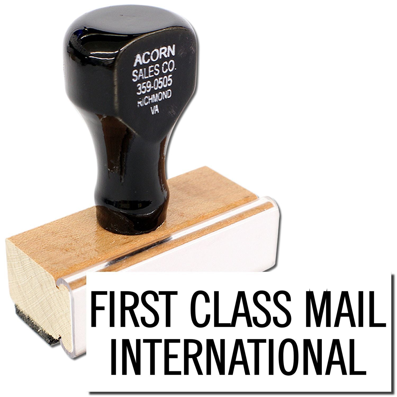 First Class Mail International stamp on wooden handle, showing Acorn Sales Co. label for mailing services.
