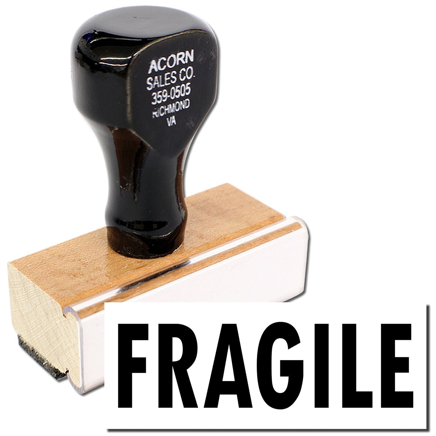 Acorn Sales Co. rubber stamp marks a fragile shipping label on a wooden ink pad, indicating handle-with-care packaging for freight and boxes.