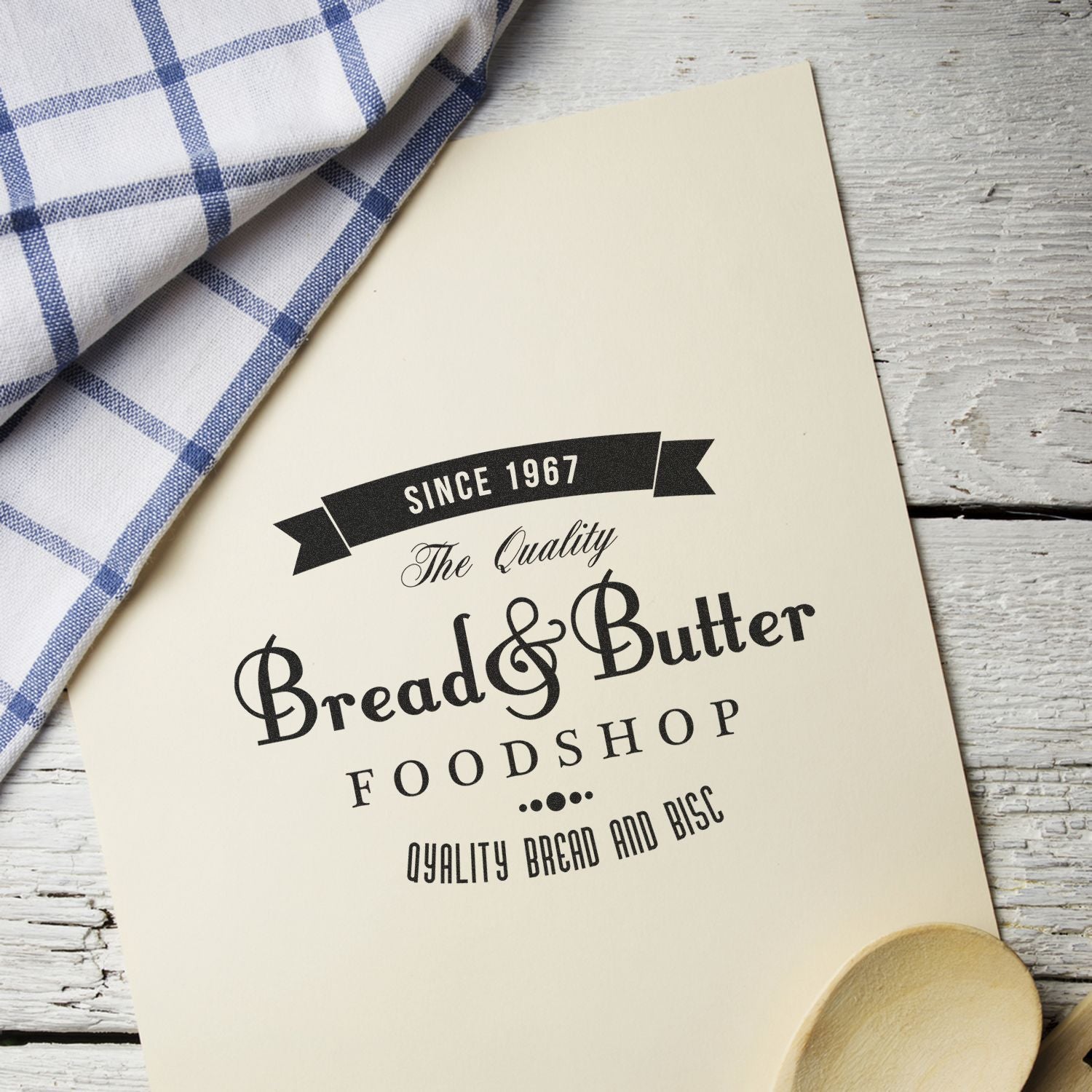 Bread & Butter Food Shop branding on a bakery label beside a blue checkered cloth, promoting quality baked goods since 1967.