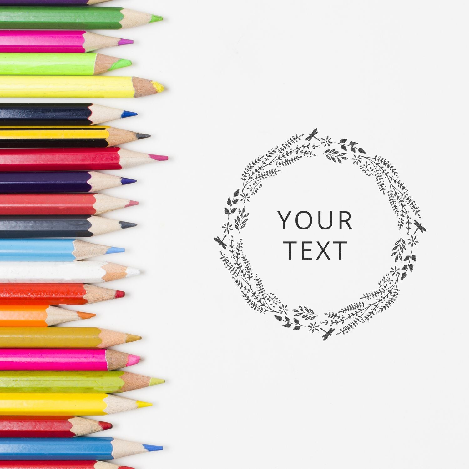 Colorful colored pencils border a white background with a decorative floral wreath and space for your text, education writing template.