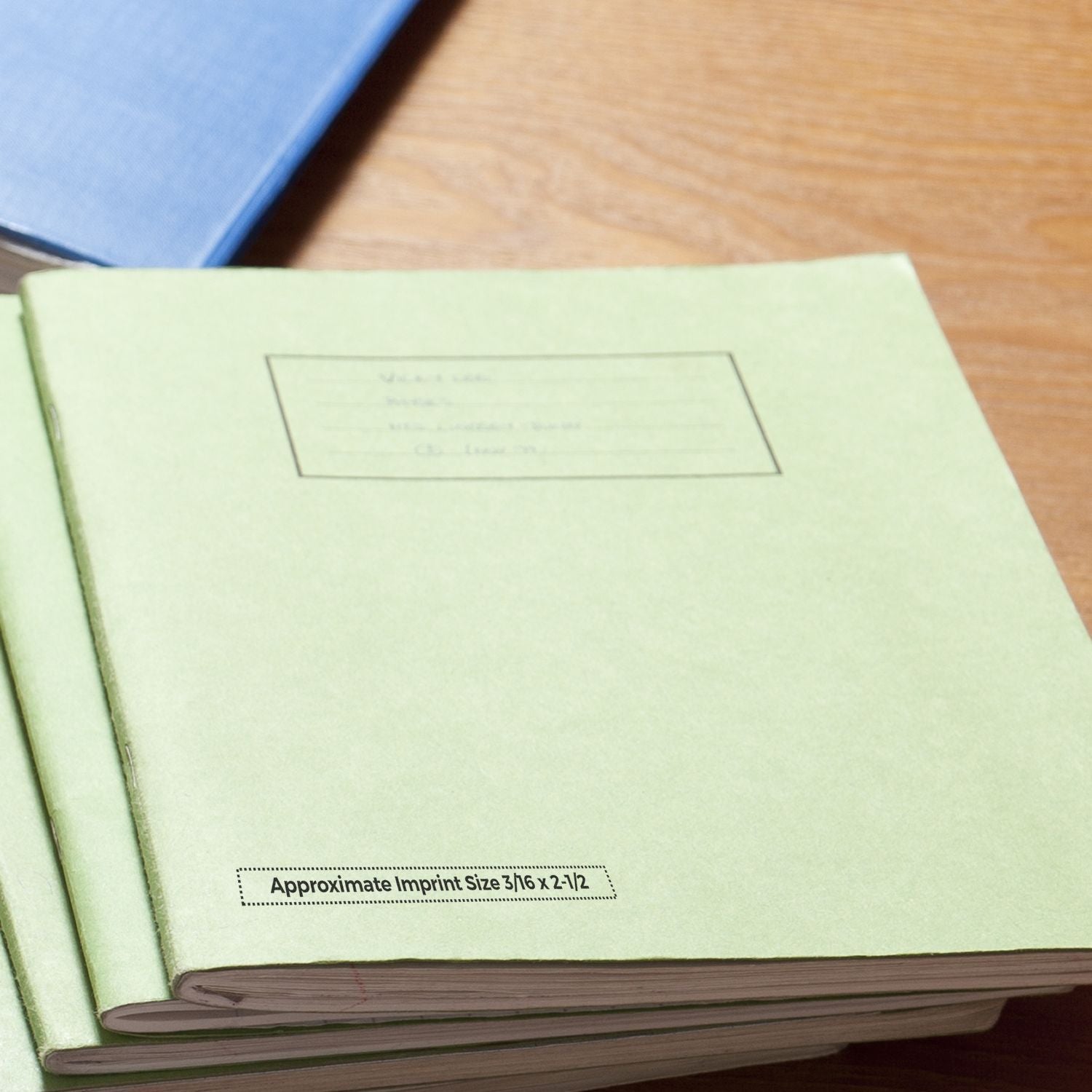 Close-up of a light green notebook showing the custom imprint area and approximate imprint size for logo branding on cover.