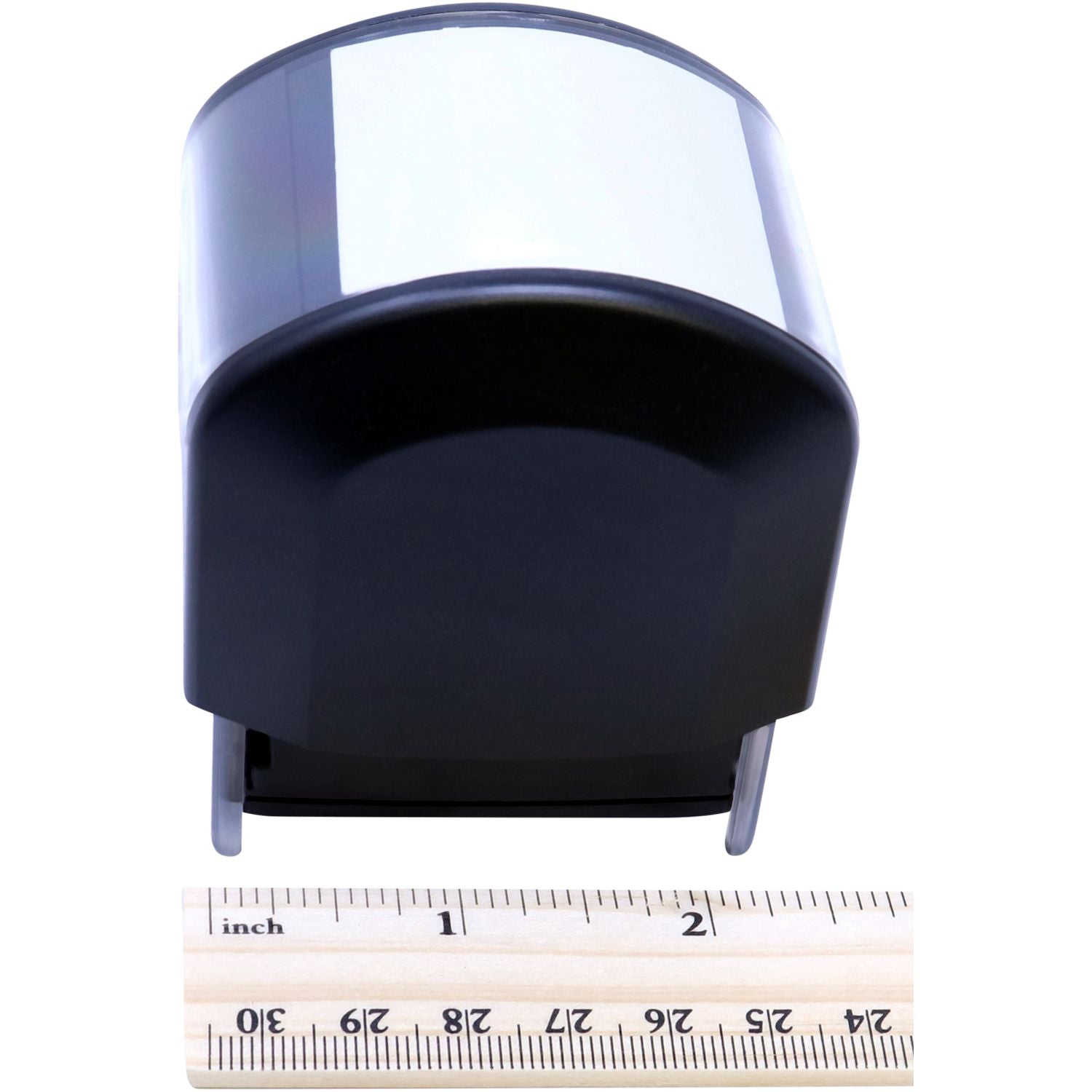 Close-up product size measurement of a small electronic device, shown with a ruler for accurate dimensions.