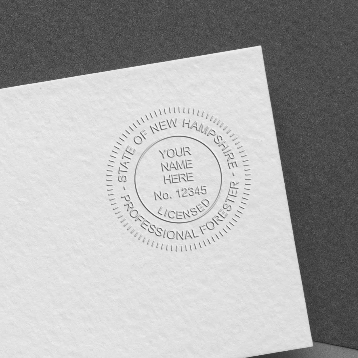 Embossed State of New Hampshire professional forester license seal on white paper with custom name and number placeholder.