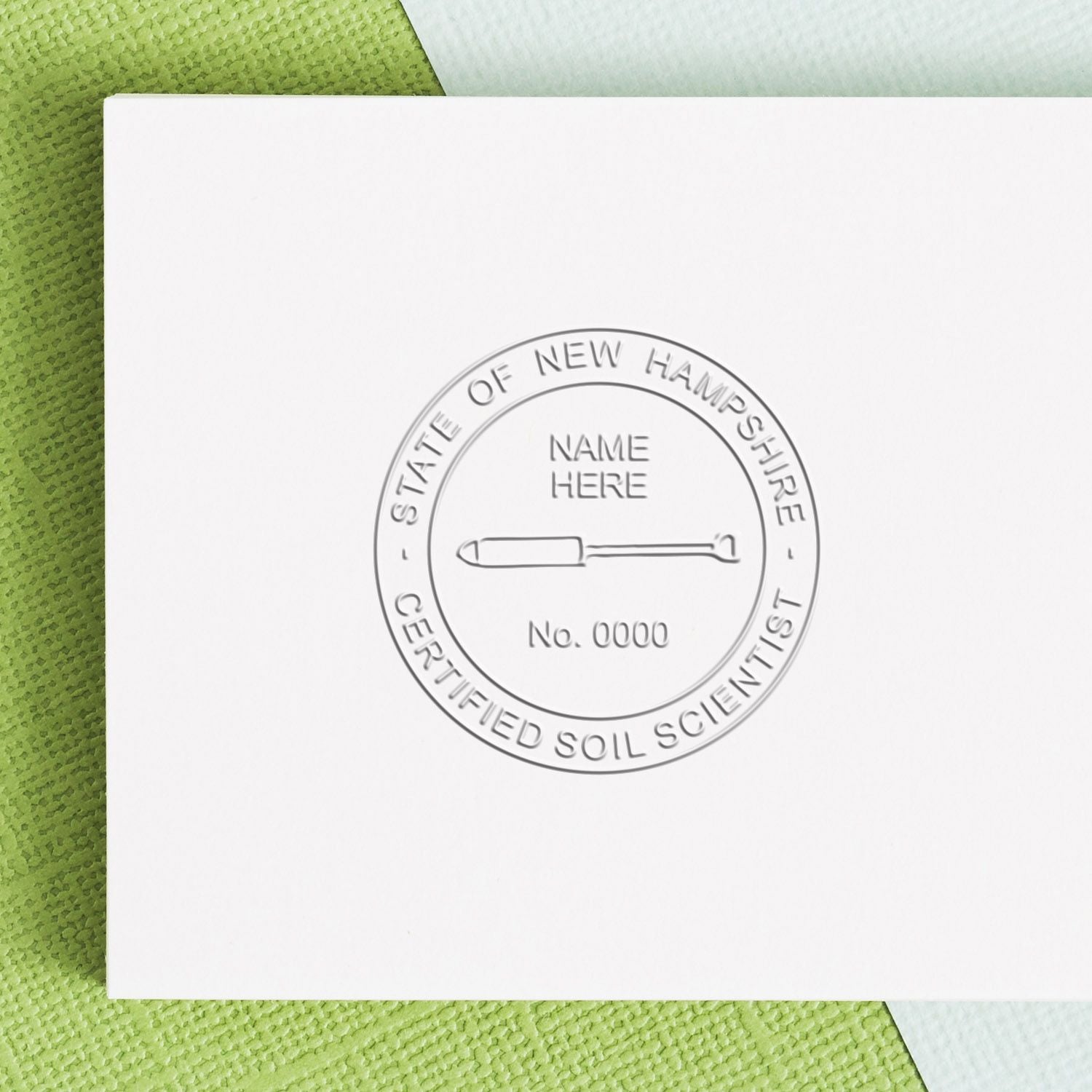Embossed State of New Hampshire Certified Soil Scientist seal on white certificate paper with a green textured background.