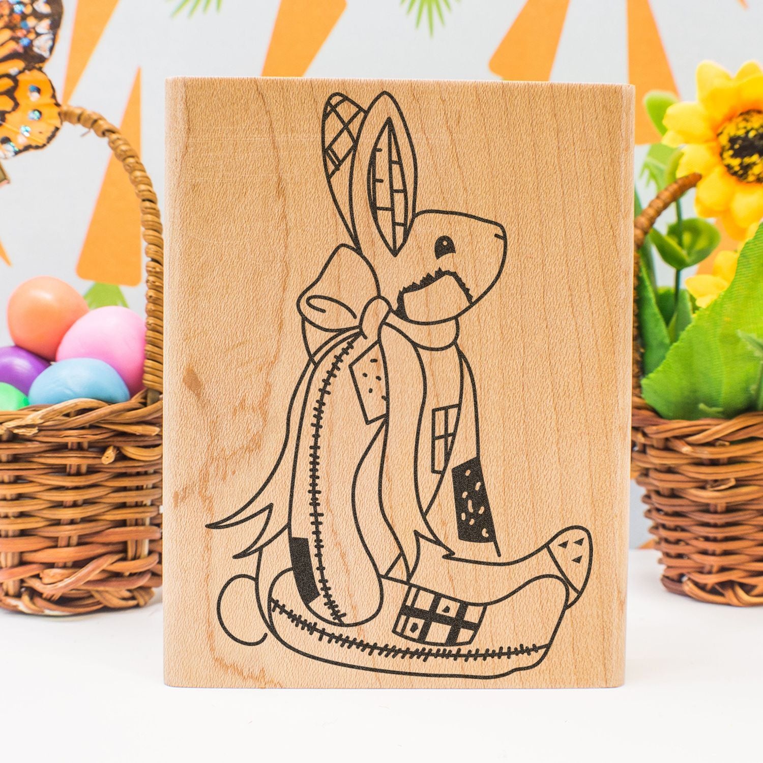 Wooden Easter bunny stamp with decorative floral eggs and spring basket background