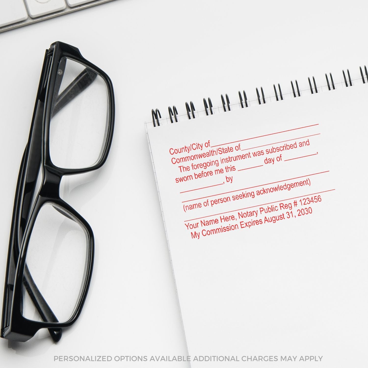 Black eyeglasses beside a notary acknowledgment pad on a white desk, with personalized options available.