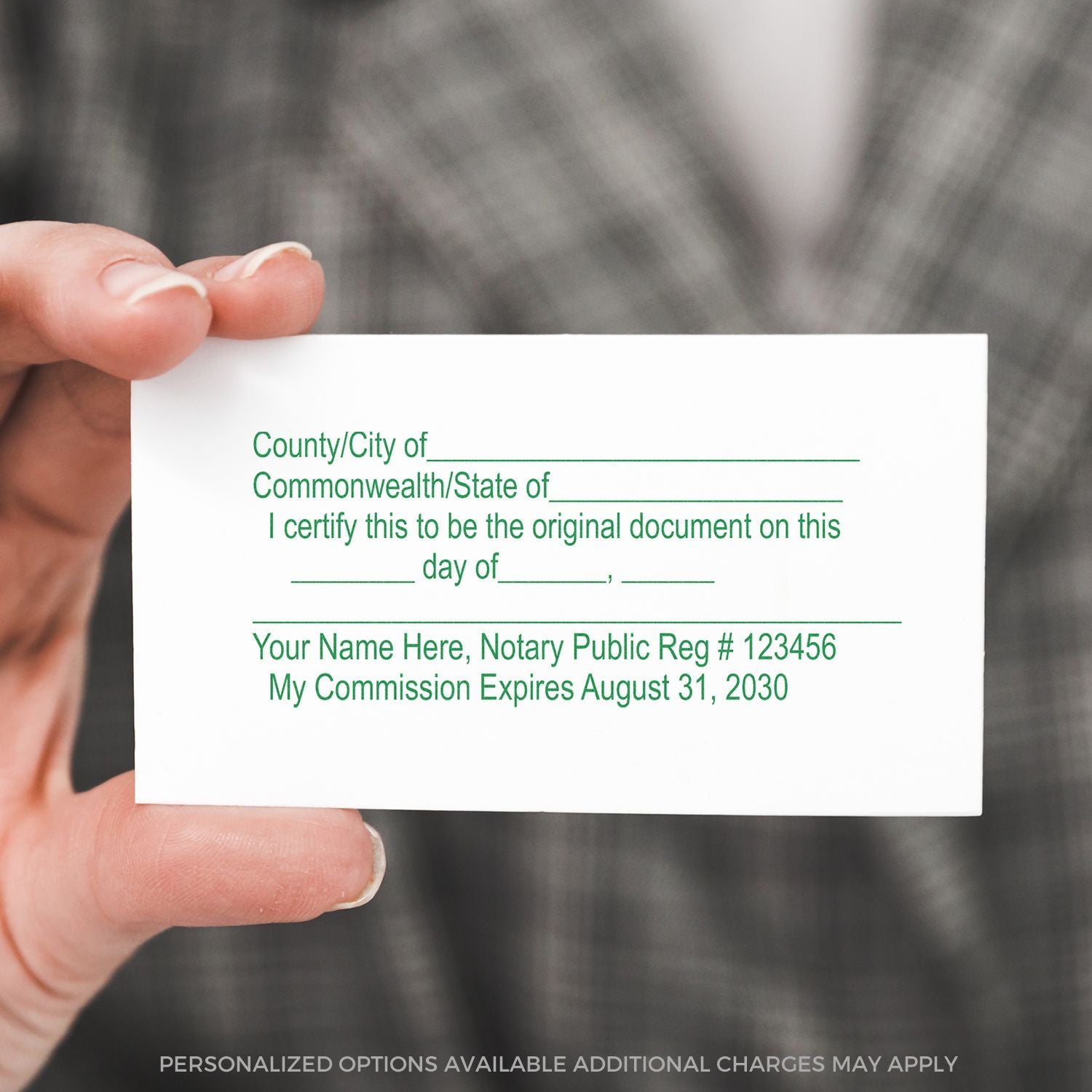 Hand holding a personalized notary public business card with commission expiration date and official notarization details.
