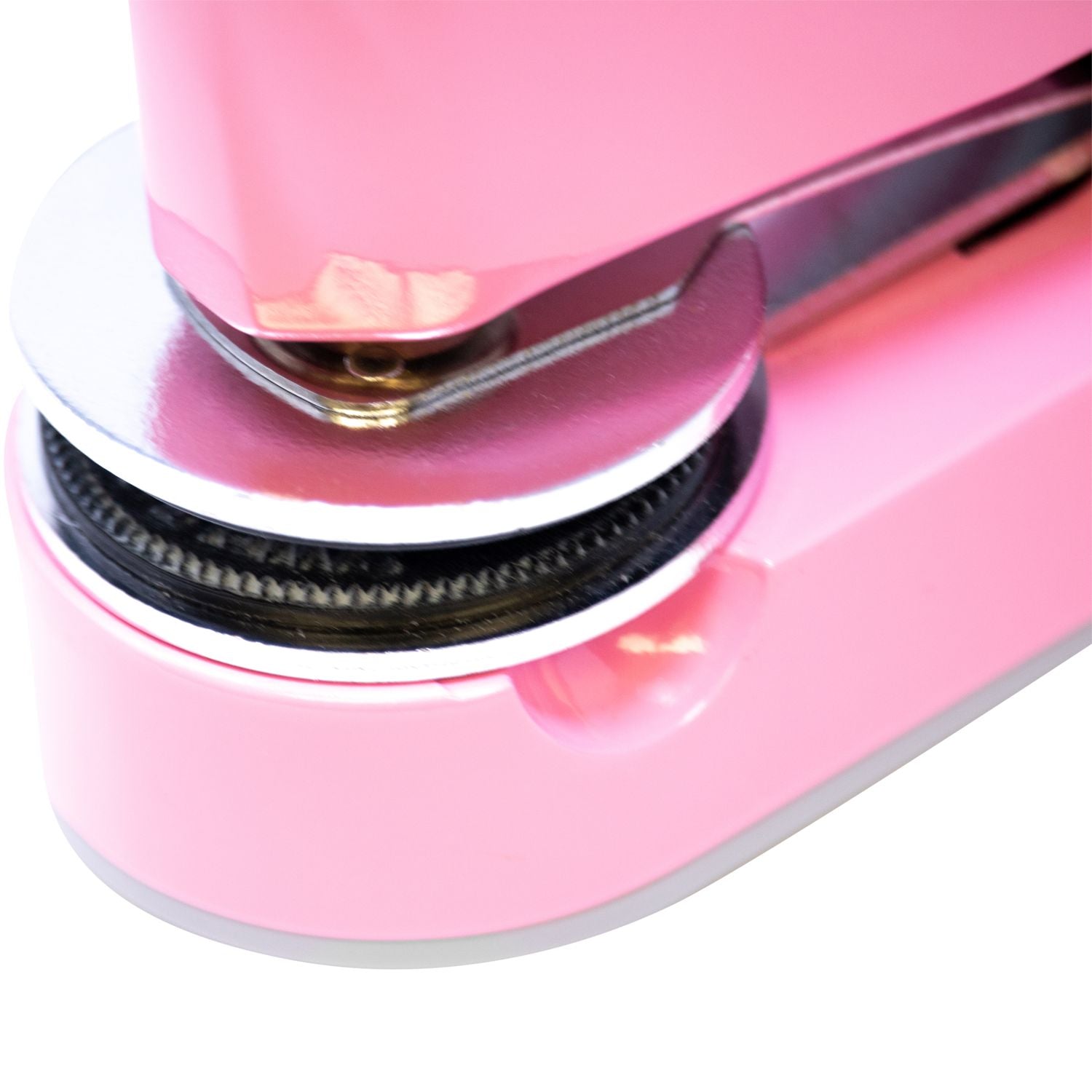 Close-up of a pink hair straightener with a sleek ceramic plate and hinge detail.