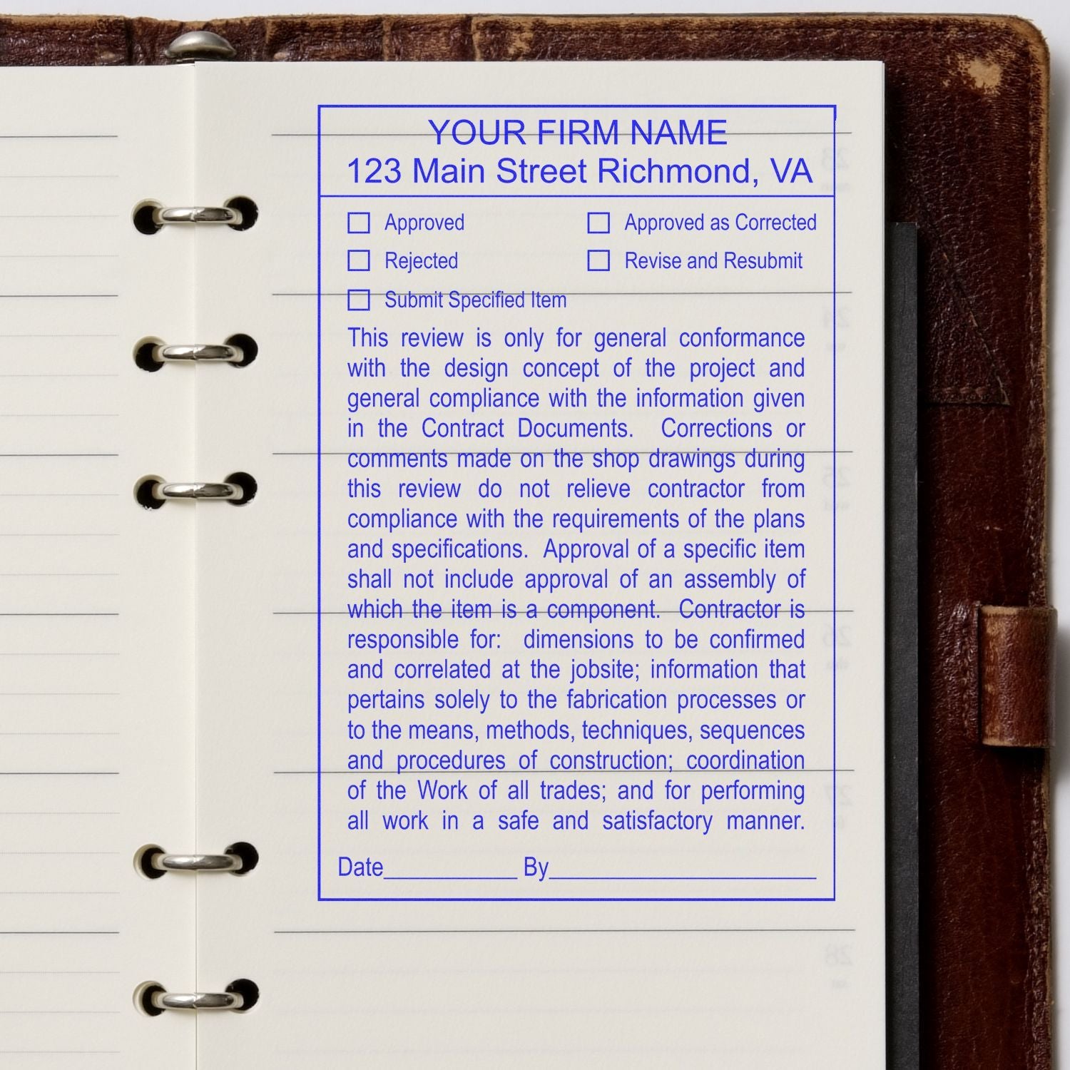 Construction submittal approval stamp on a binder page with blue review form and checkboxes inside a ring notebook.