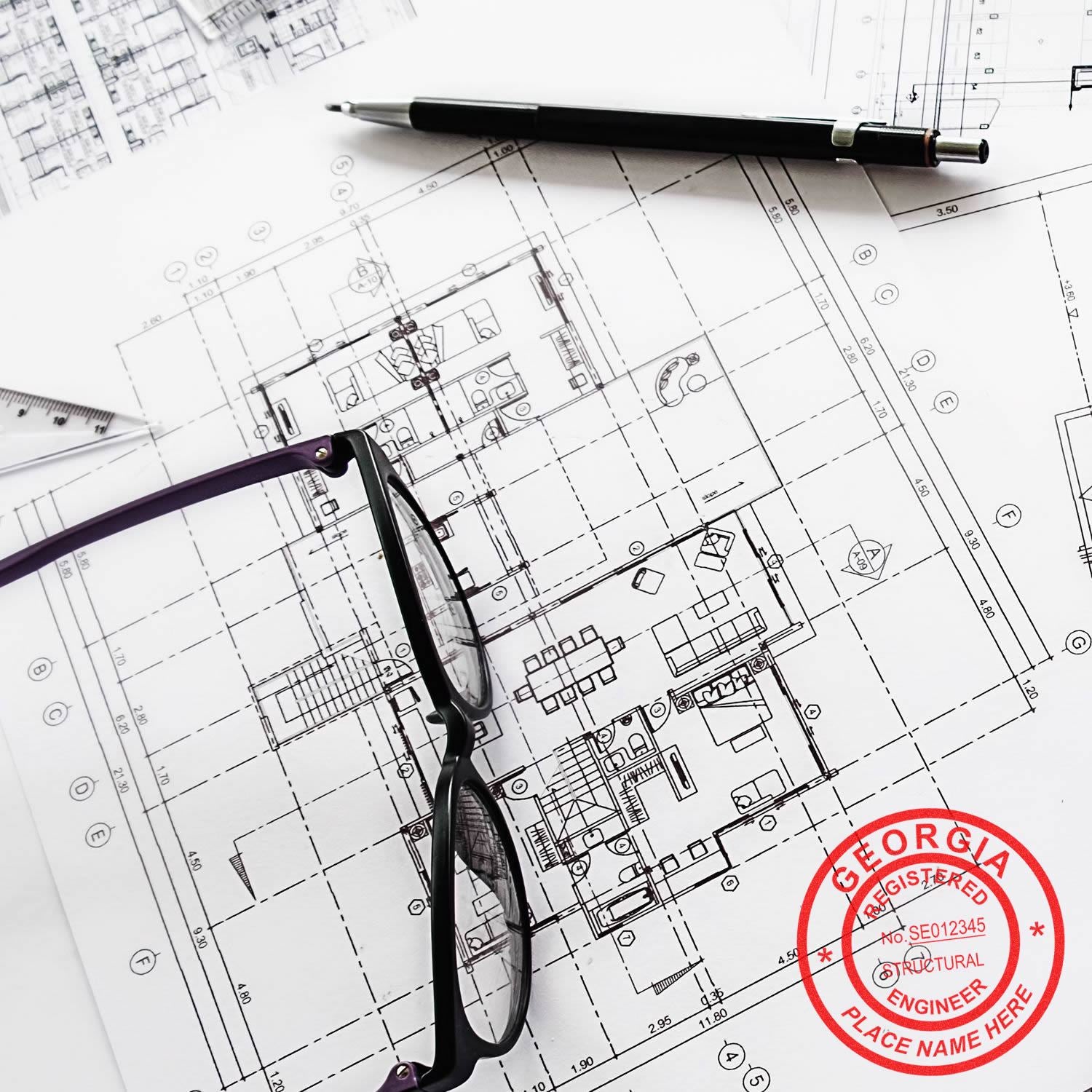 Architectural blueprint with pen and eyeglasses, featuring a structural engineer stamped floor plan design.