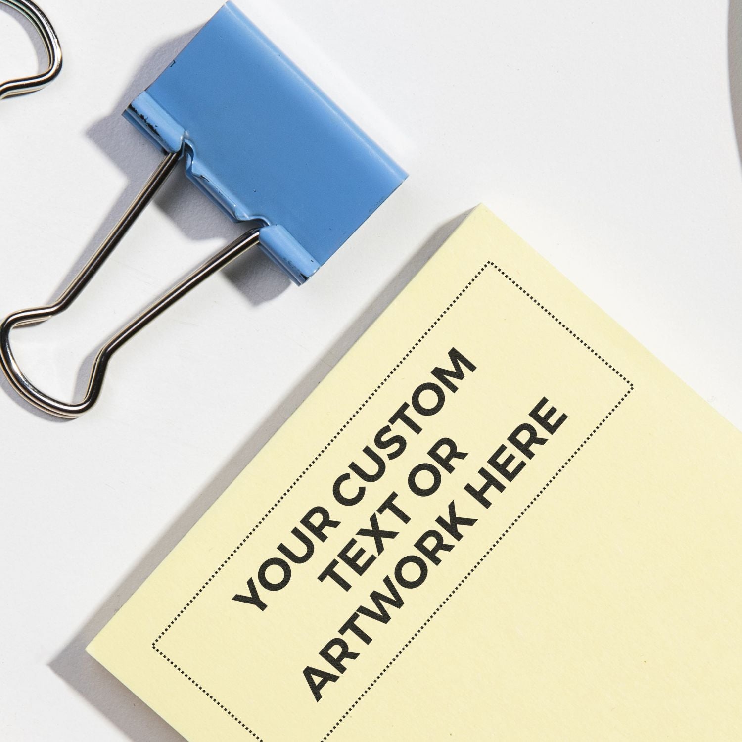 Close-up of blue binder clip holding a custom print card templateYour Custom Order with Artwork Here space for branding projects