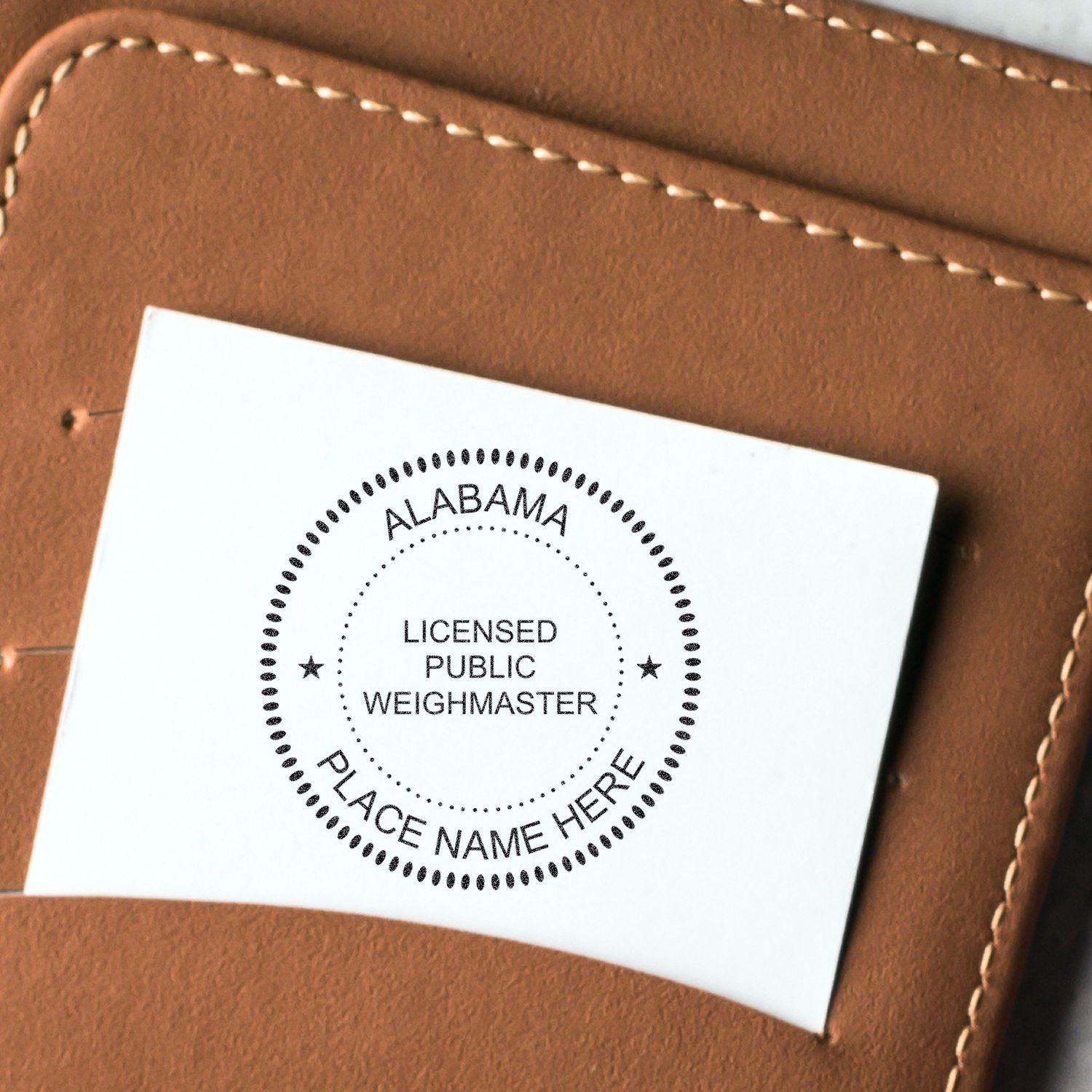 Alabama Licensed Public Weighmaster seal card on brown leather background