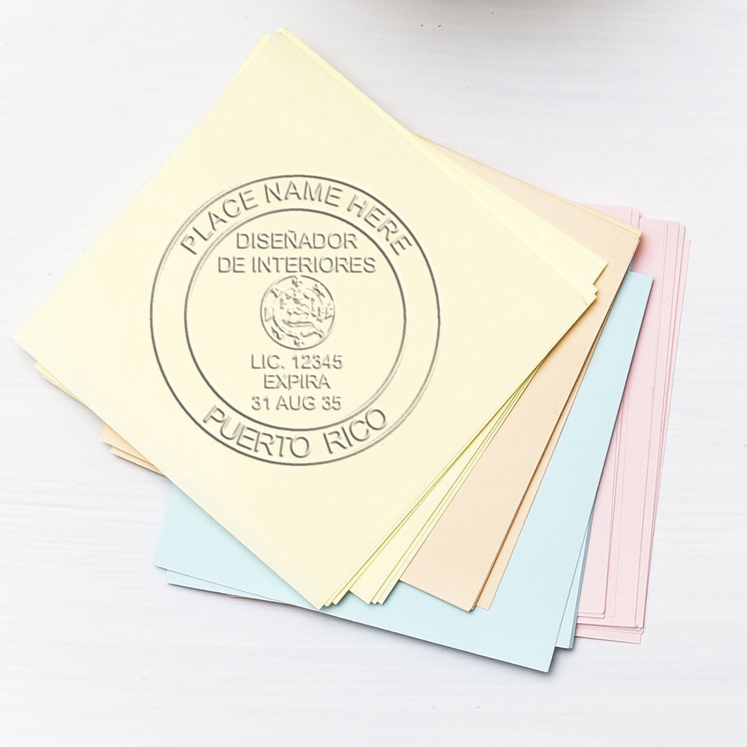 Pastel paper sheets with a Puerto Rico interior designer license stamp for document branding.