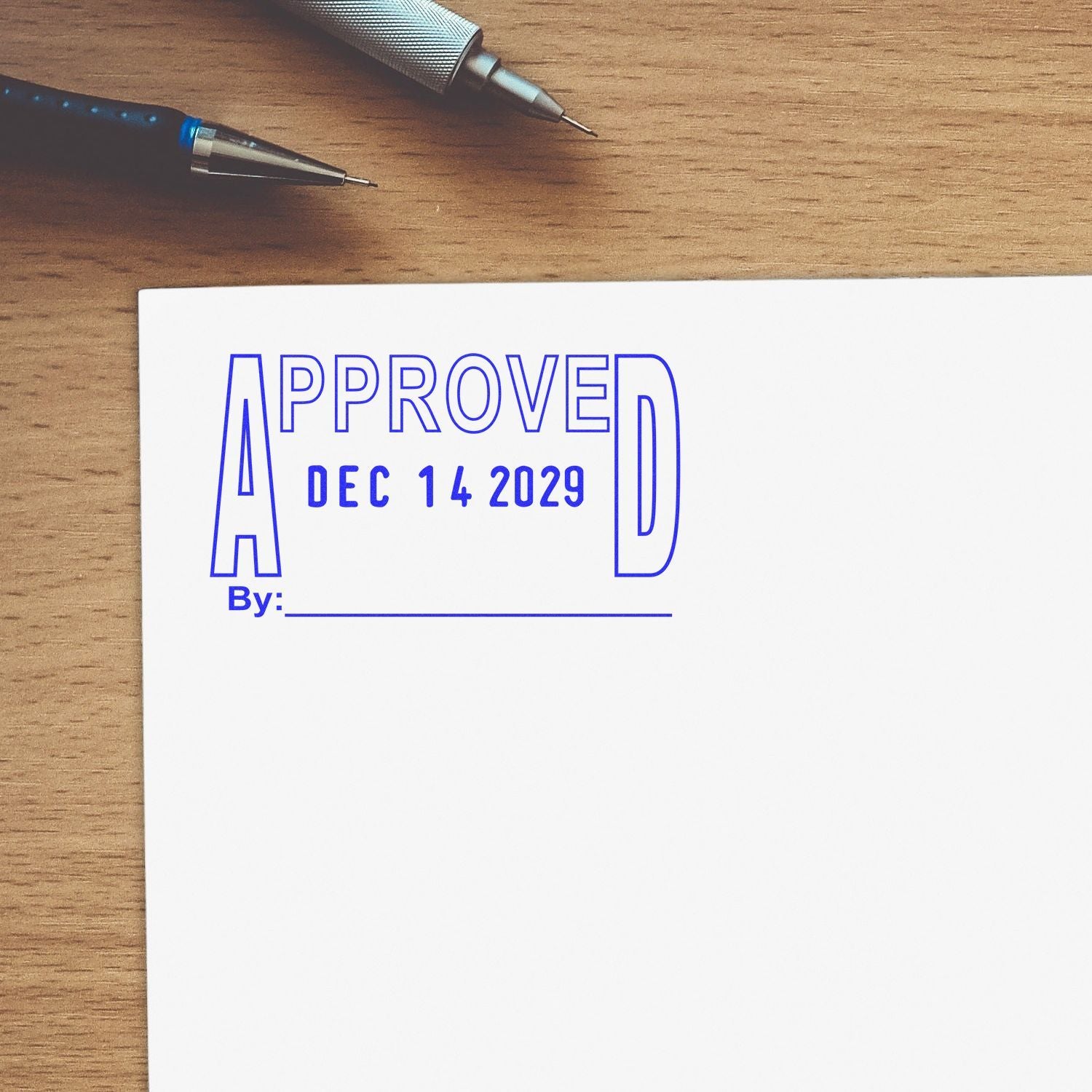 Approved stamp on blank document dated Dec 14, 2029, with pens on a wooden desk, business paperwork concept.
