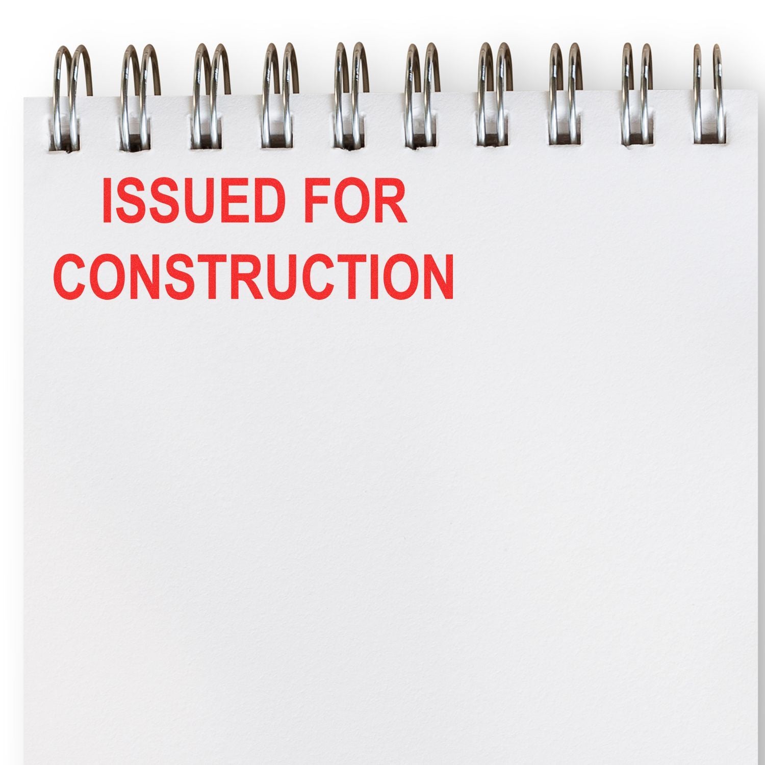 Spiral notebook page with bold red text reading ISSUED FOR CONSTRUCTION on a clean white background.