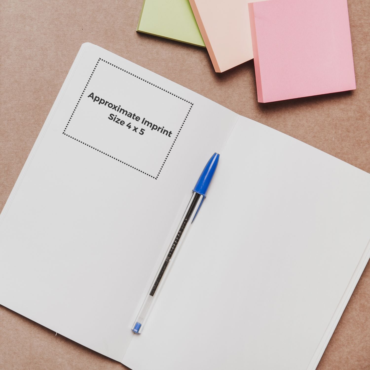 Notebook mockup showing approximate imprint size 4x5 with pen and pastel paper stacks for custom printing guidance