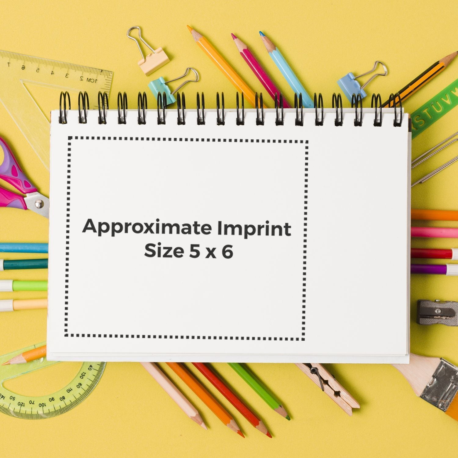Stationery mockup for custom printingApproximate imprint size 5x6 on notepad with pencils, binder clips, and ruler.