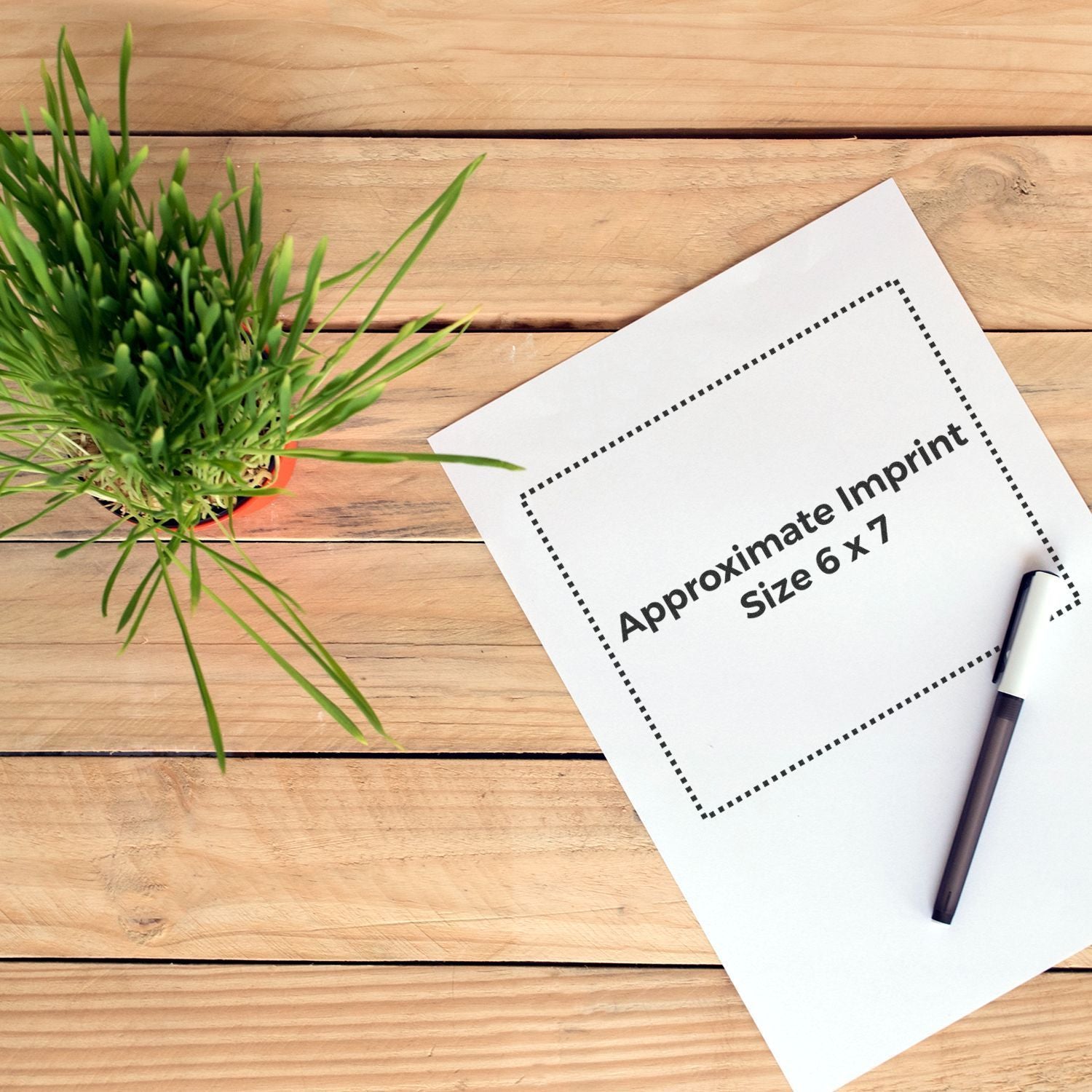 Approximate imprint size 6x7 on a printing label card for branding, next to a pen and green plant on wooden table.