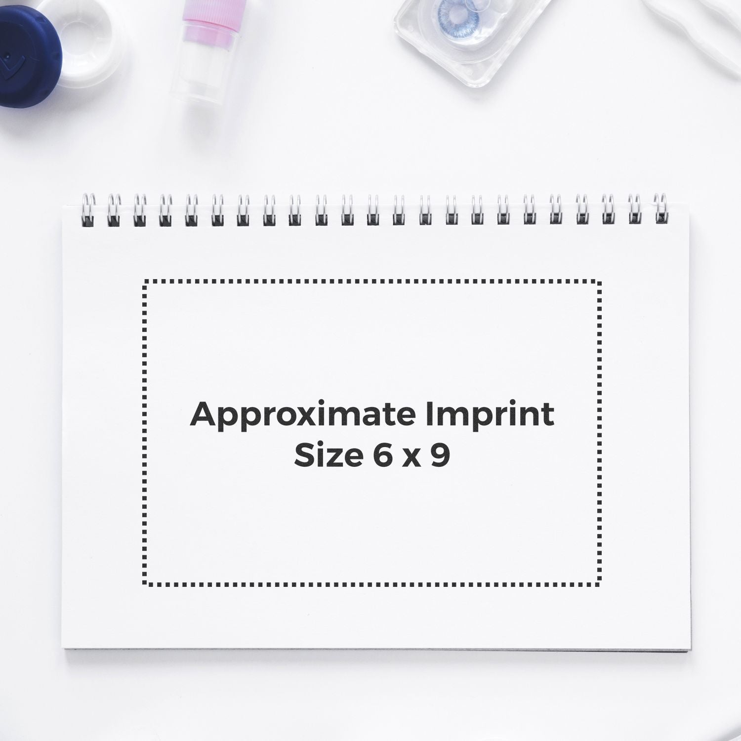Notebook product imprint size guide showing approximate 6x9 branding area on a white spiral journal template.