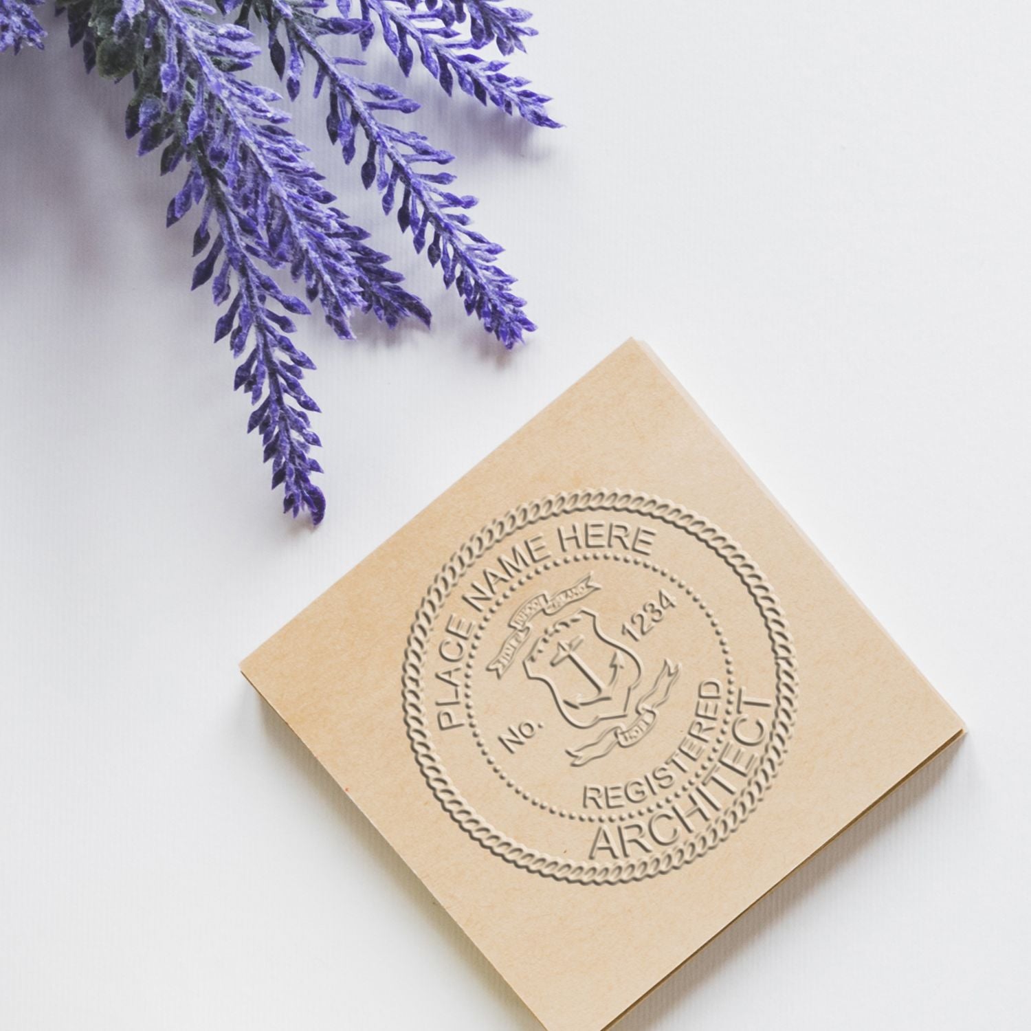 Embossed registered architect stamp on beige paper with purple foliage on a white background