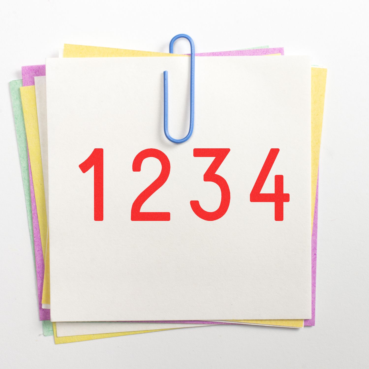 Blank note cards with paper clip and red 1234 on top, colorful stacked paper background.