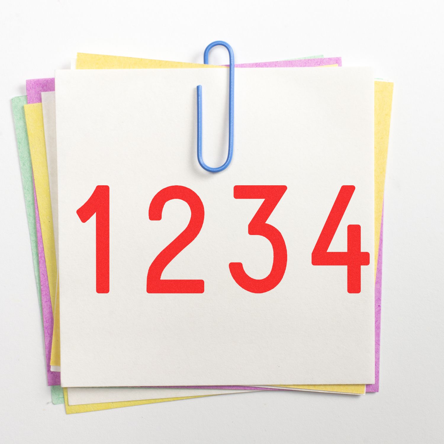 Colorful stack of paper note cards clipped together with a blue paperclip and bold red numbers 1234 on top.