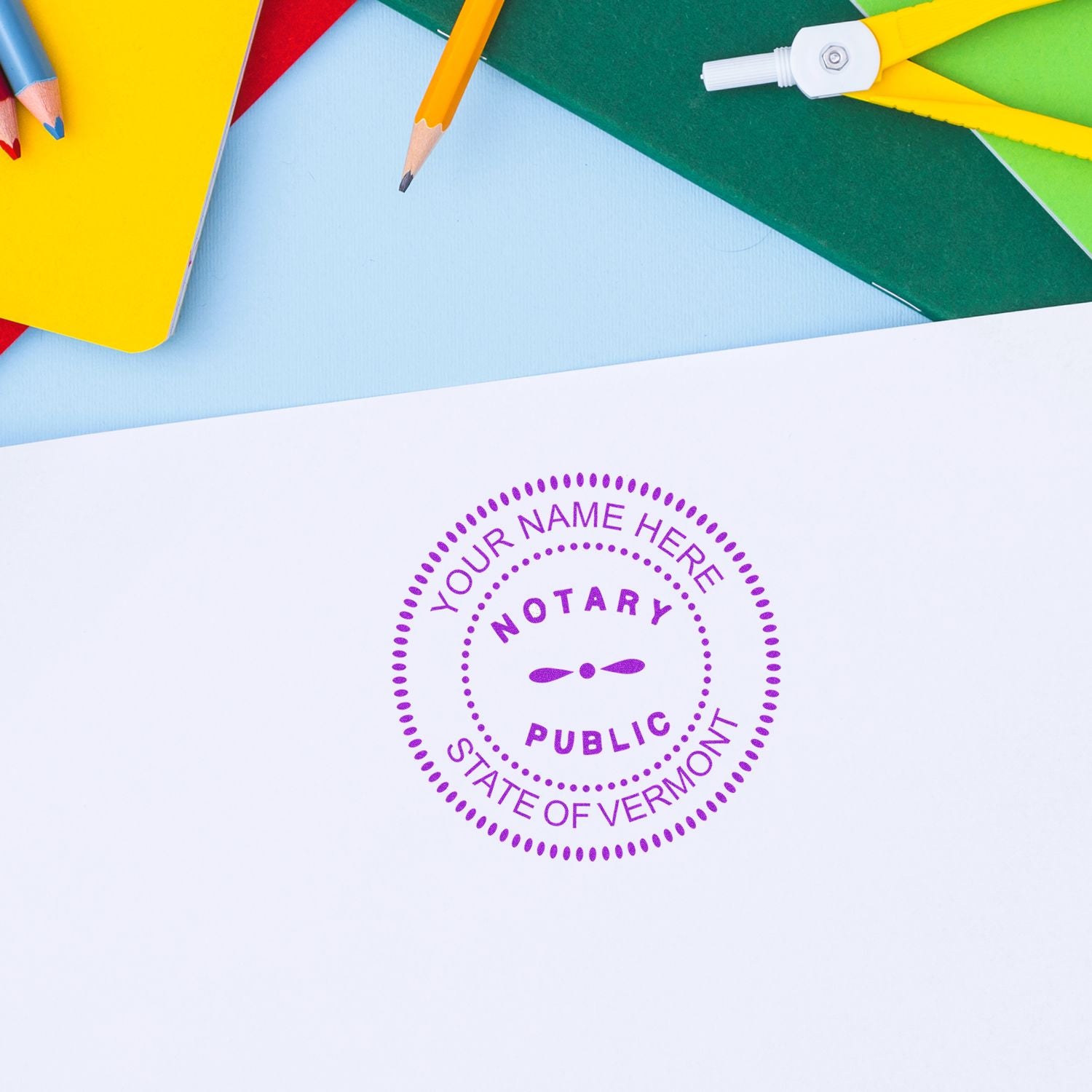 Notary public stamp on blank paper with colorful pencils and stationery, Vermont notary seal concept.