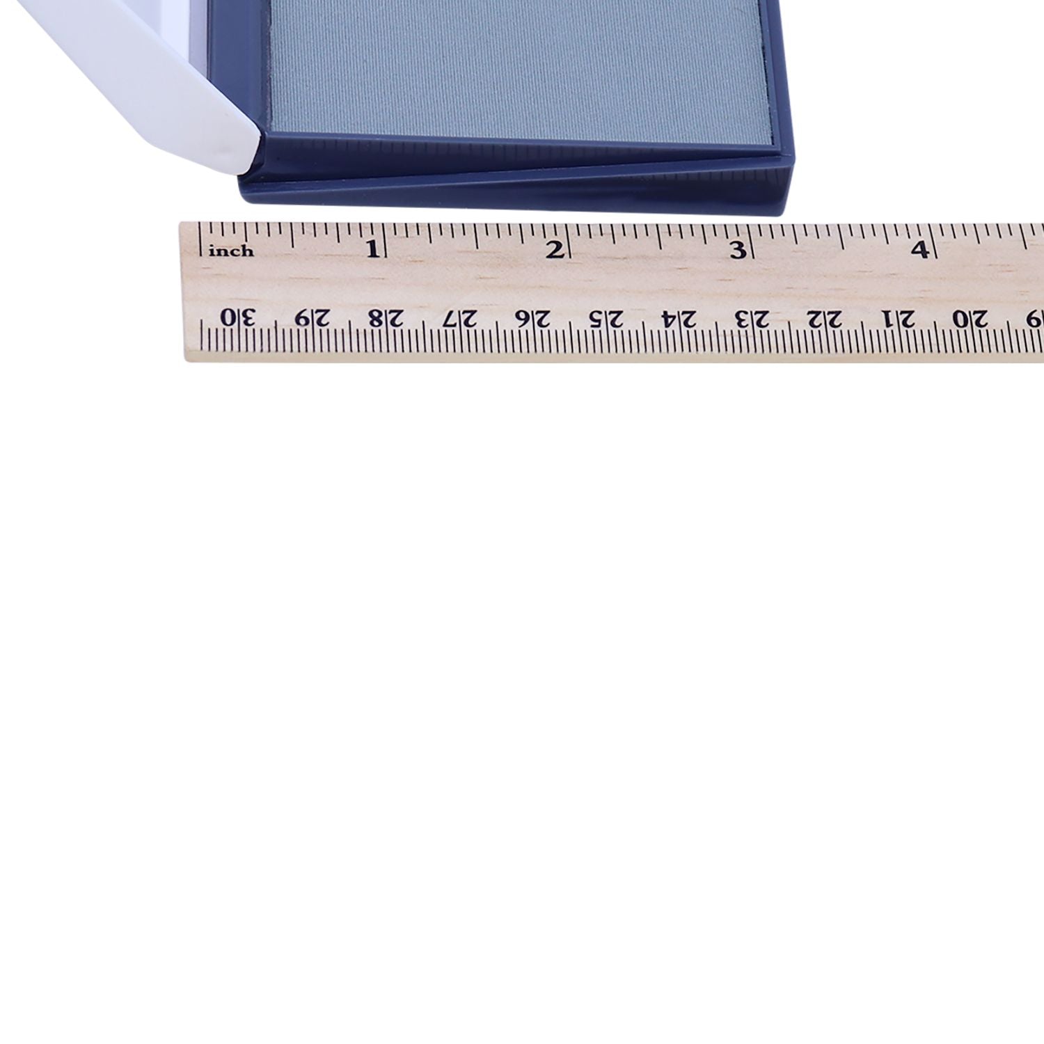 Close-up of a blue fly swatter with a ruler for size reference.
