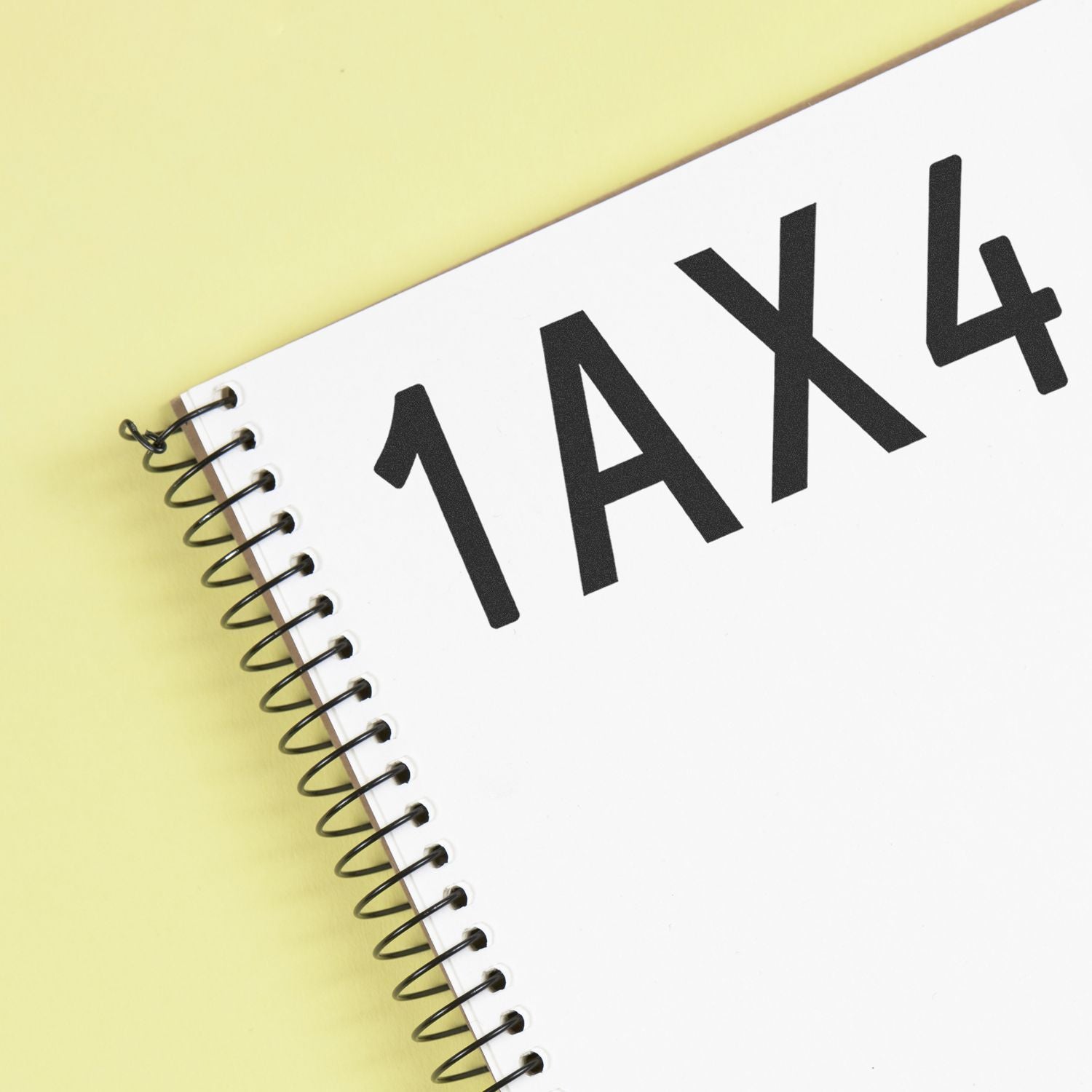 Spiral notebook with bold tax text on a yellow background