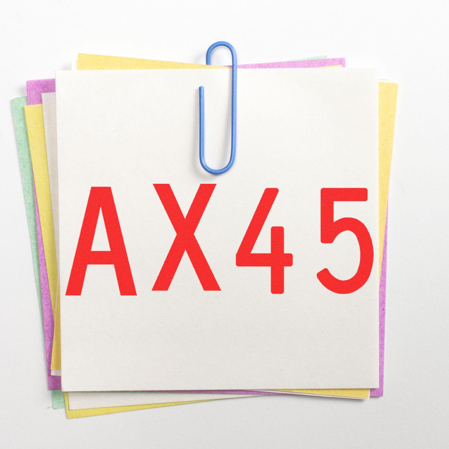 Colorful stack of office paper notes clipped with a blue paperclip, labeled AX45 on a white background.