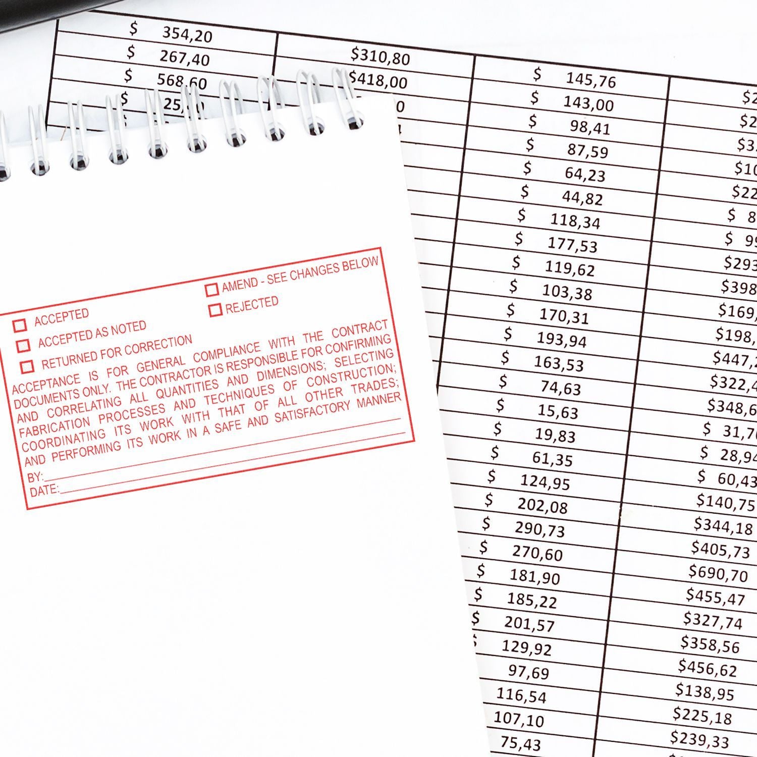 Spiral notebook with red approval stamp over financial spreadsheet and dollar amounts, symbolizing accounting, budget review, and contract approval.