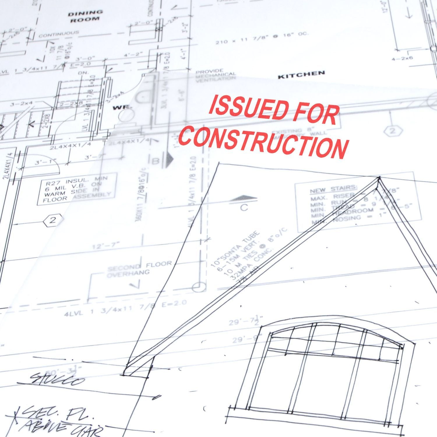 Architectural blueprint with Issued for Construction stamp on house floor plan drawings.