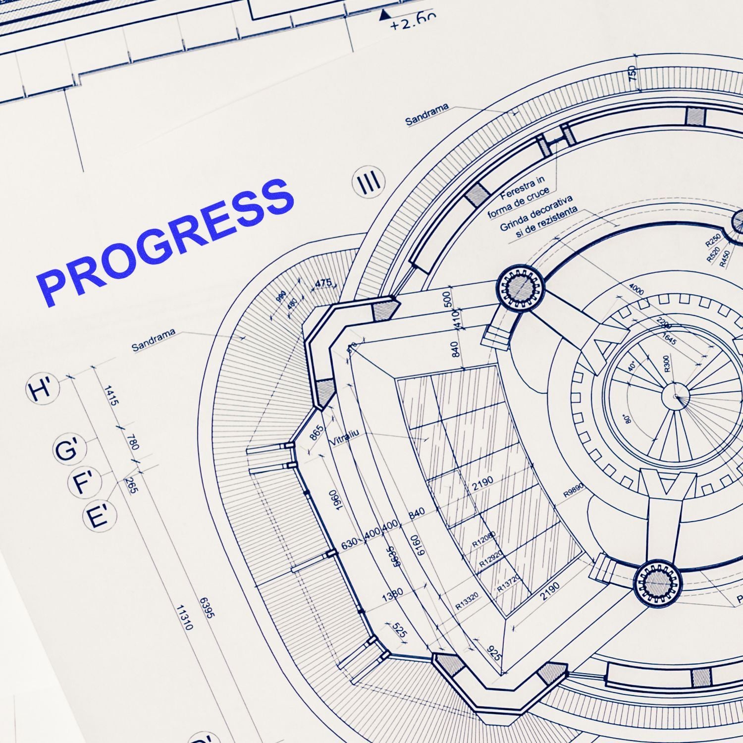 Architectural blueprint of a circular building design labeled progress, showing detailed construction and engineering plans.