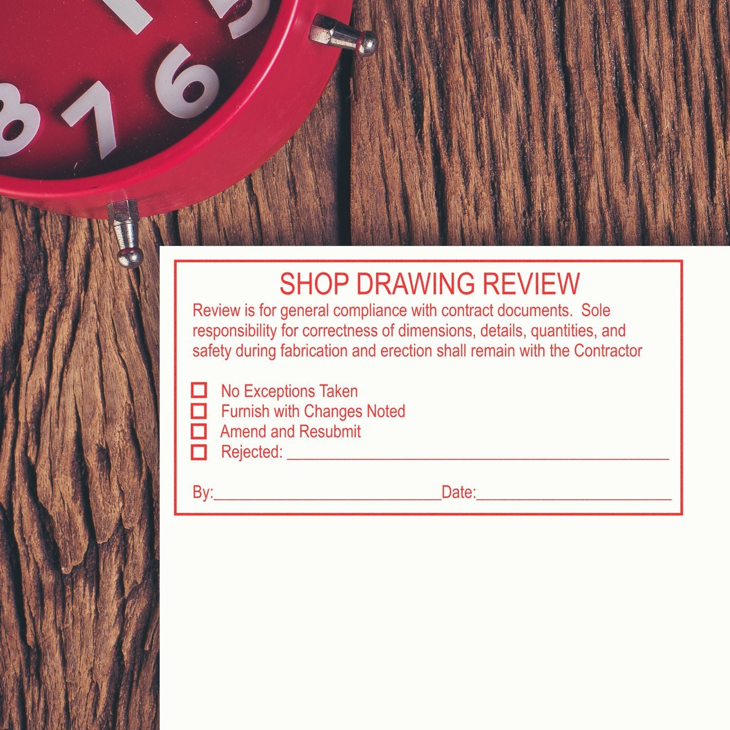 Red clock and shop drawing review form on wooden background, construction blueprint approval document.