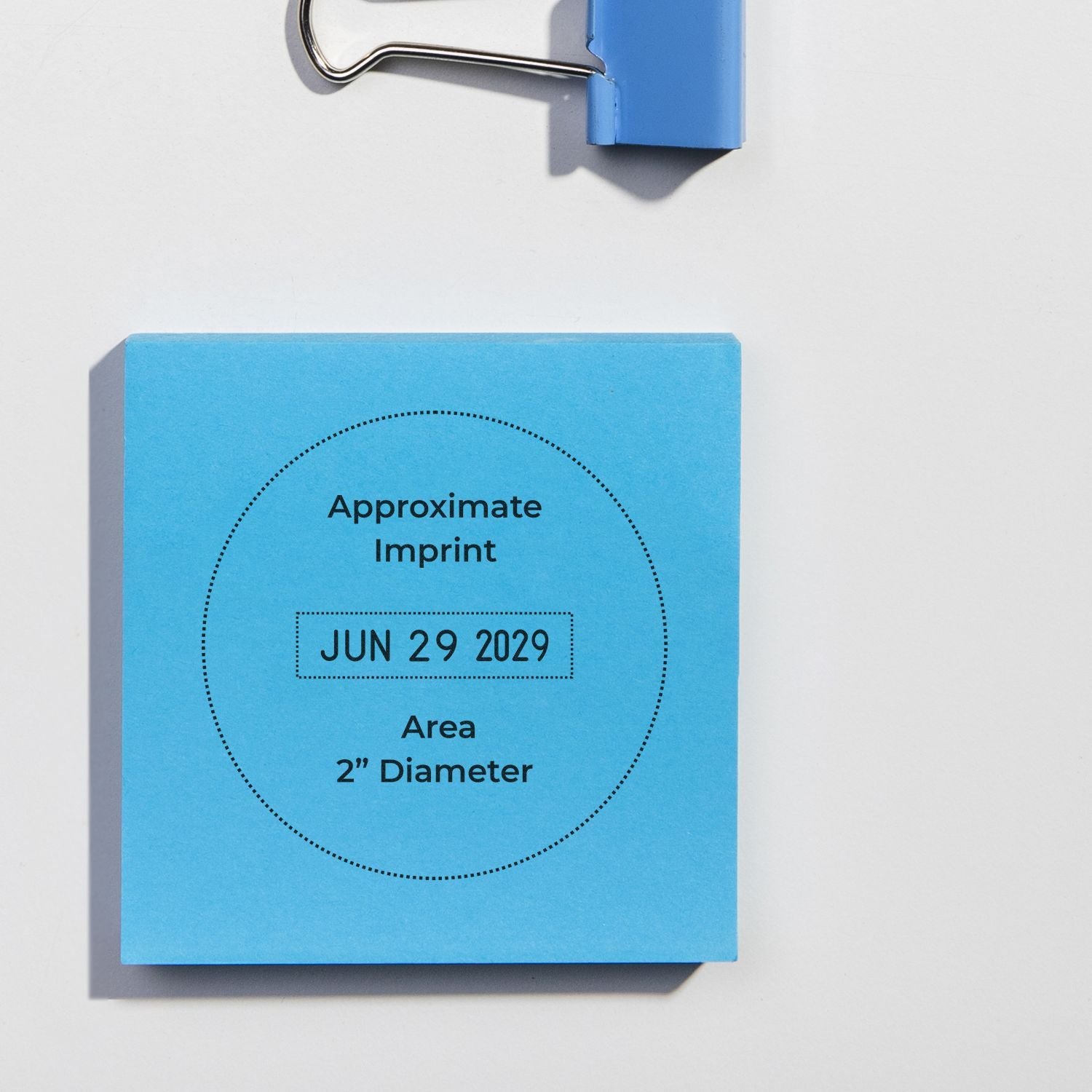 Blue sticky note mockup showing approximate imprint area and June 29, 2029 date stamp on a clipboard.