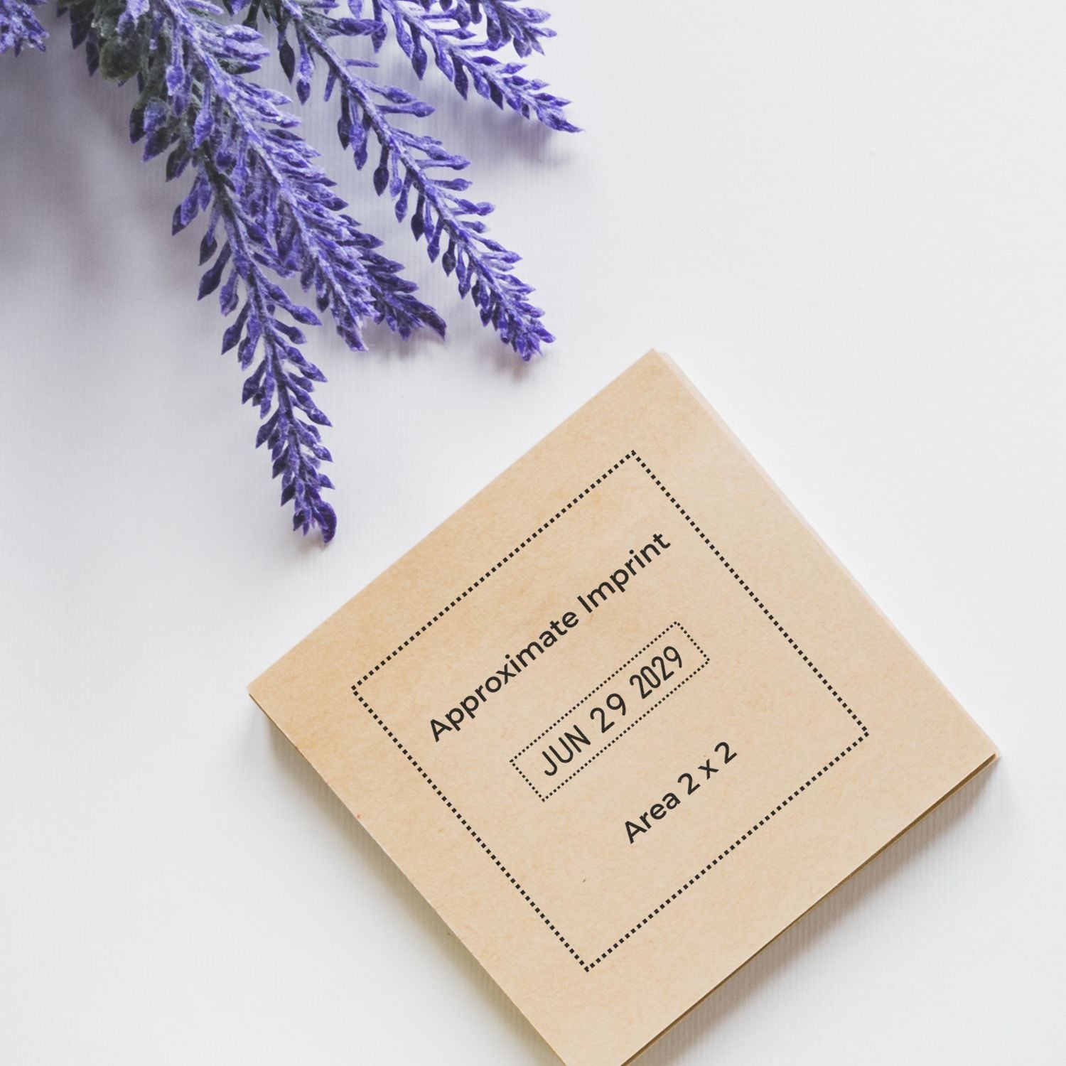 Lavender sprigs beside a beige paper sample labeled Approximate Imprint with date JUN 29 2029 and Area 2x2 on a white background.