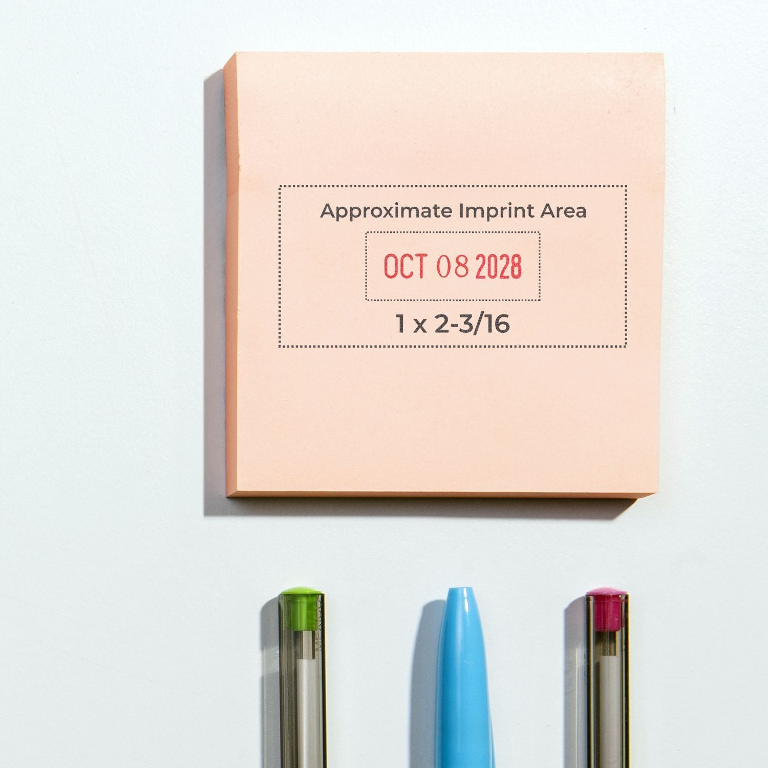 Custom promotional sticky note pad with approximate imprint area, date stamp, and pens on white background