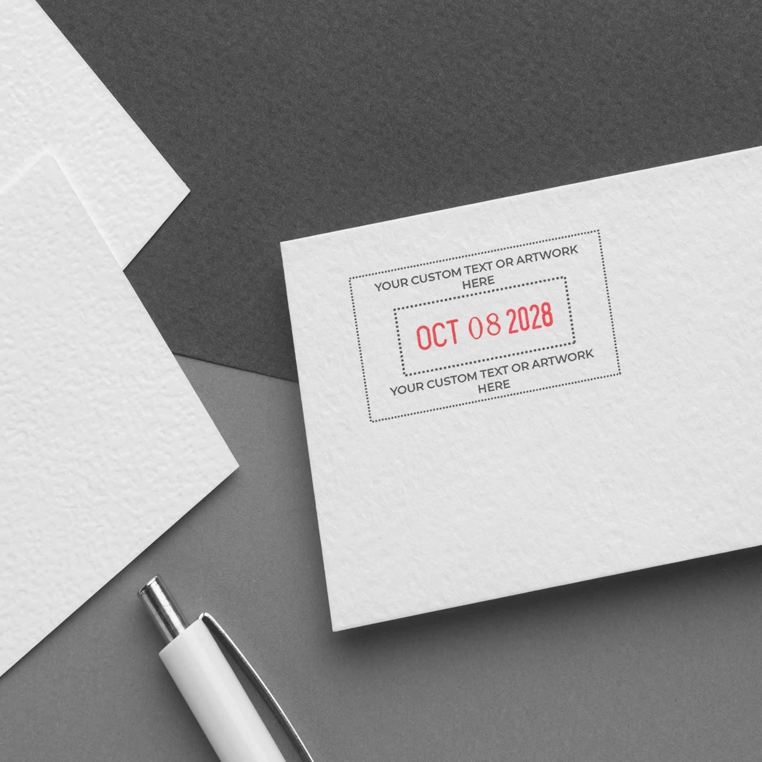 Blank envelope mockup with custom date stamp, white stationery, and pen on gray background for branding and invitation design