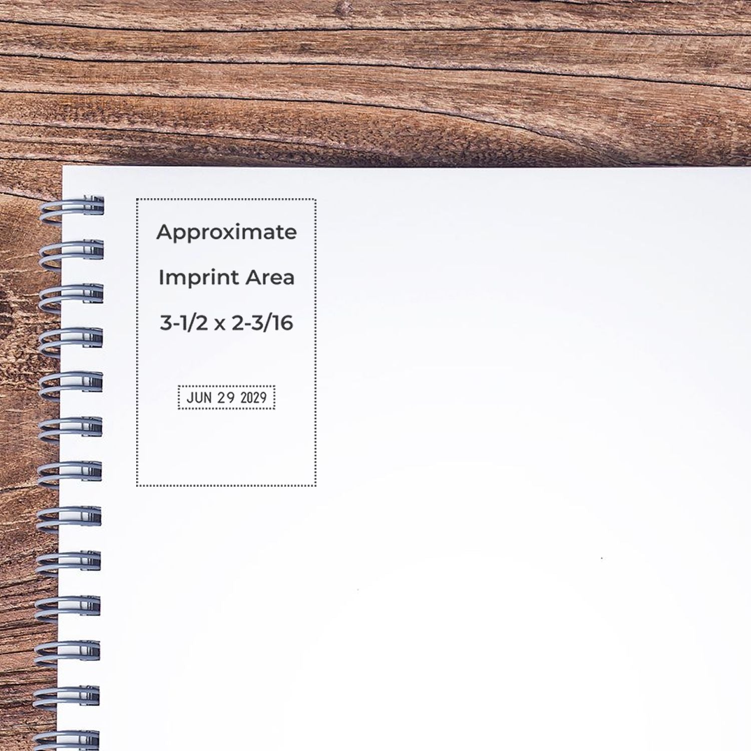 Spiral notebook mockup on rustic wood background with approximate imprint area and date stamp placeholder for custom branding.