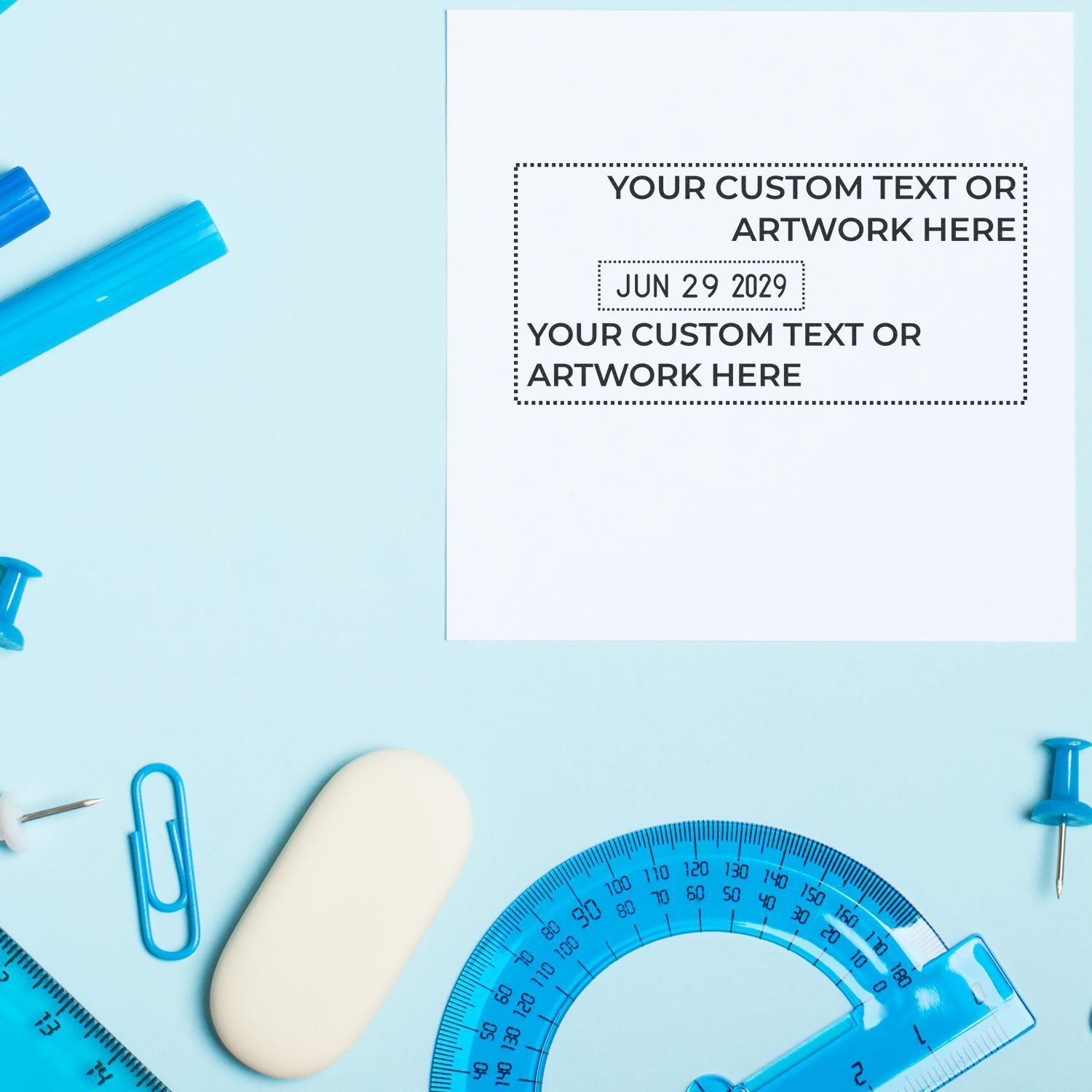 Blue school supplies flat lay with blank custom text card, protractor, ruler, paper clips, and push pins on a pastel background.