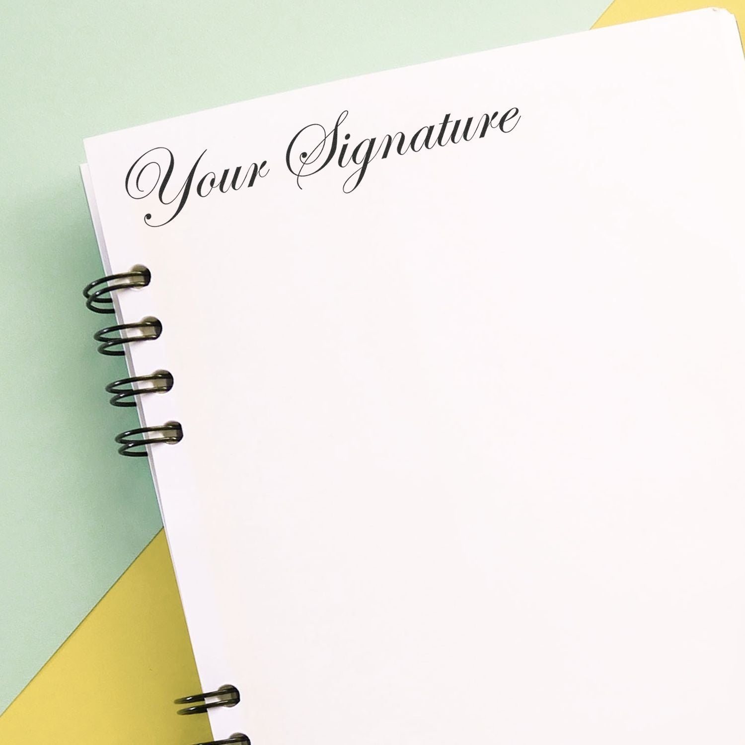 Minimalist spiral notebook page with Your Signature text on a pastel background, perfect for branding and stationery design.
