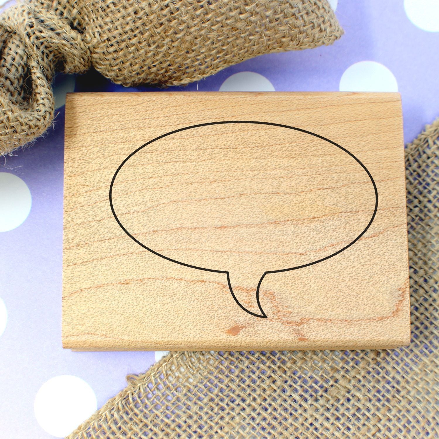 Blank speech bubble wooden sign on burlap background, rustic decorative text template.