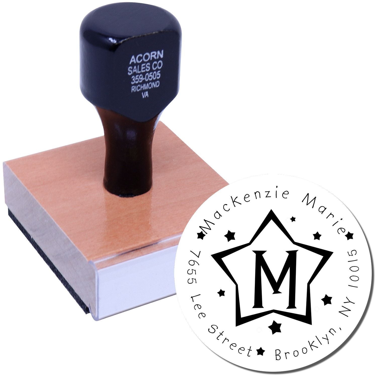 Blue rubber stamp handle and wooden base featuring Acorn Sales Co address, for document marking and business branding.