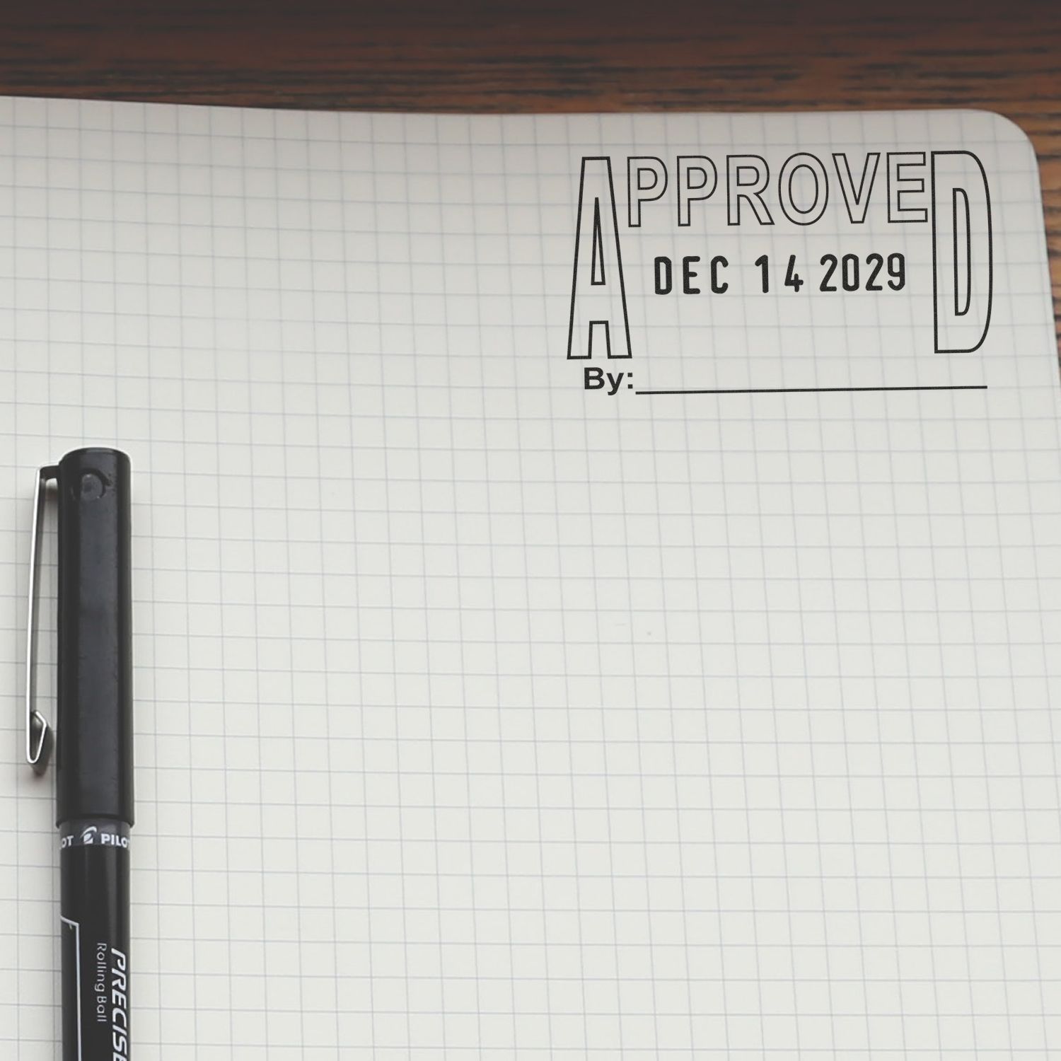 Bullet journal page with Approved stamp dated Dec 14, 2029 and a black pen on grid paper.